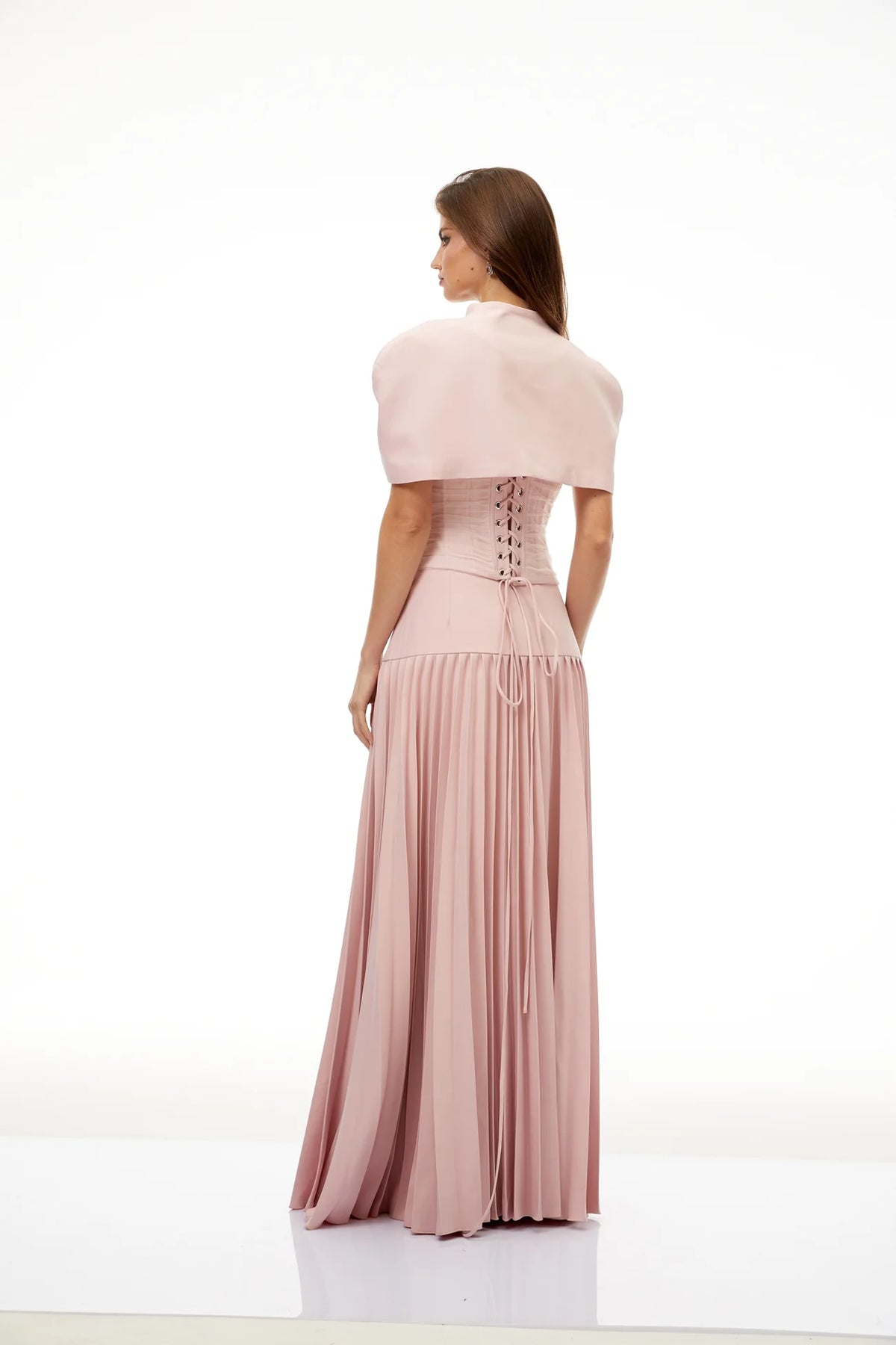 Back view of blush corset top with pleated maxi skirt