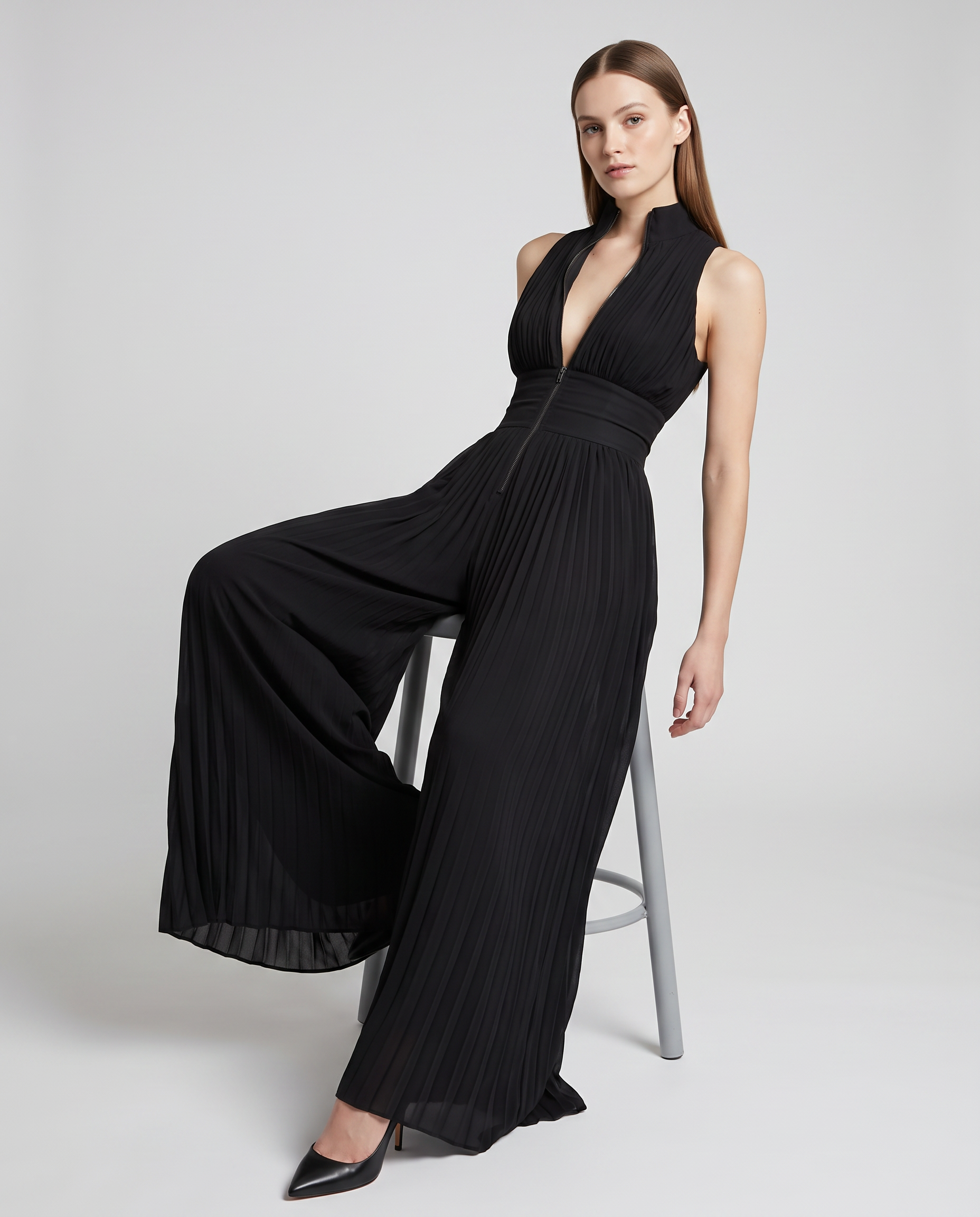 Black pleated V-neck wide-leg jumpsuit with flowing, draped wide pant legs