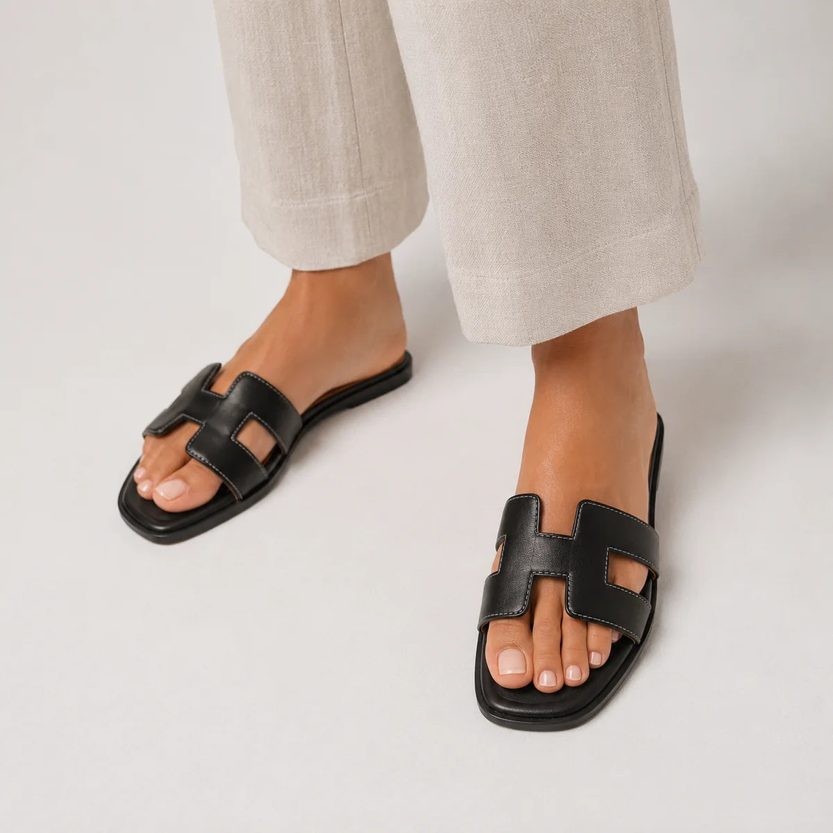Black leather slide sandal with H-strap and open toe
