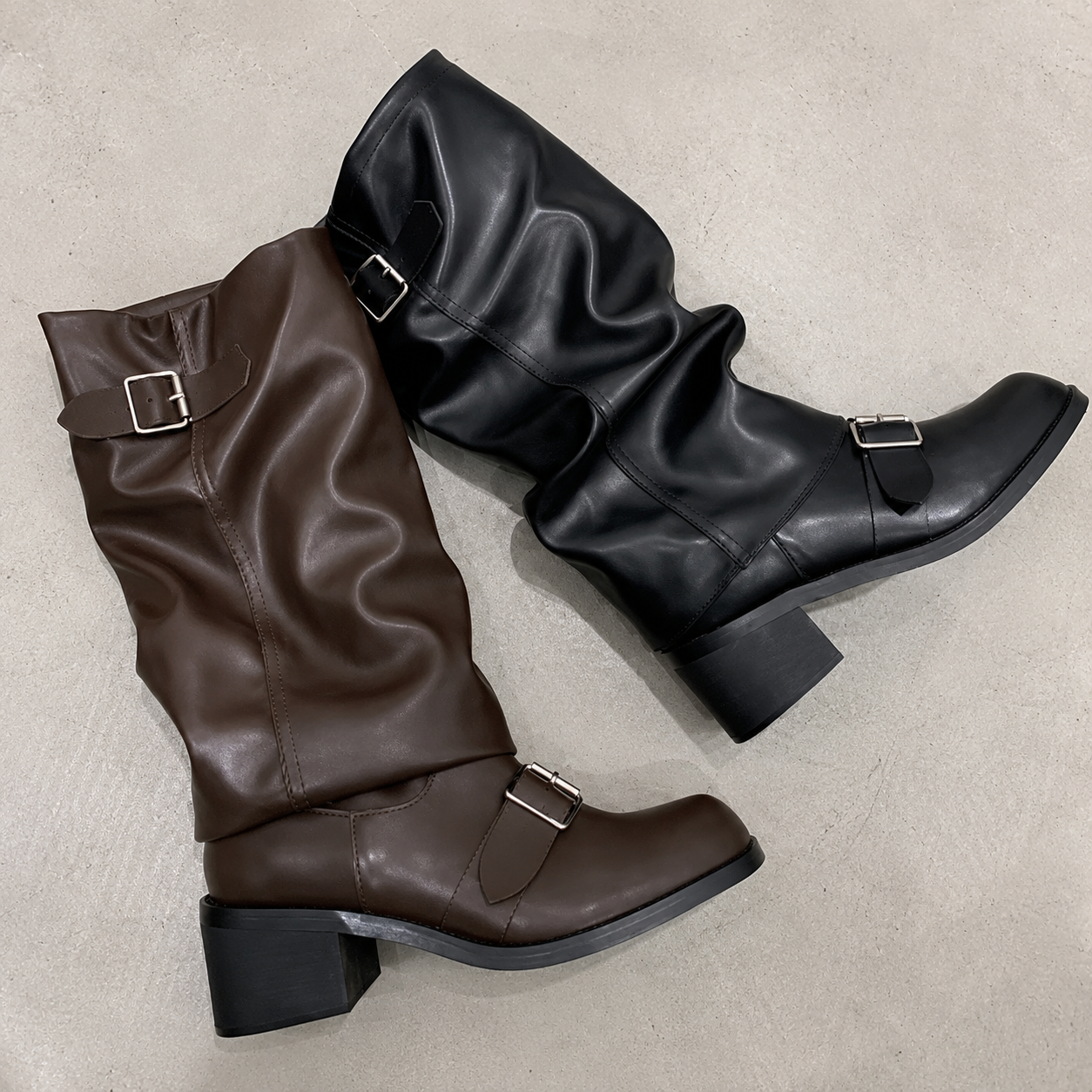 Brown and black knee-high platform boots with buckled straps and block heel
