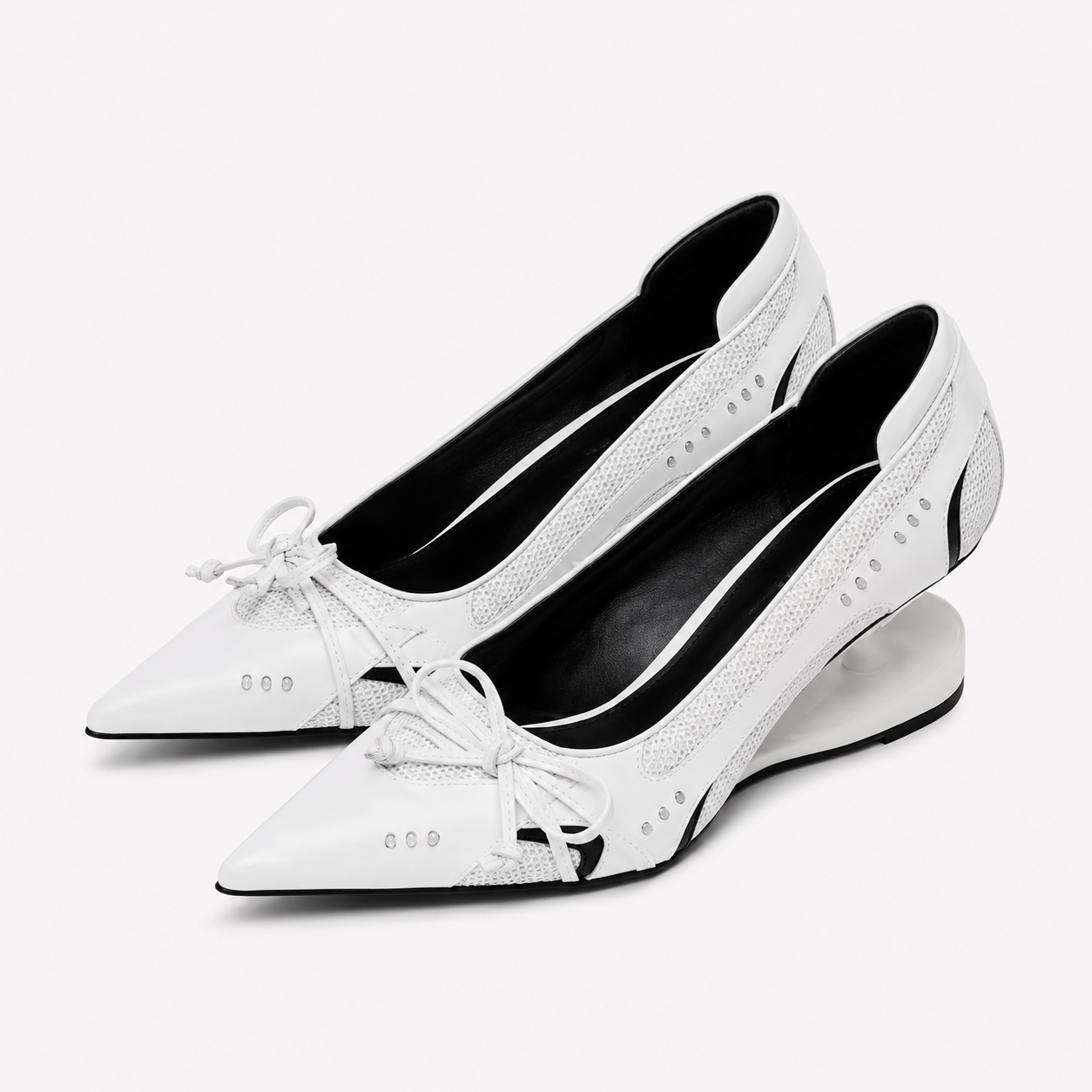 White Mary Jane pumps with pointed toe, lace bow, and low sculpted heel