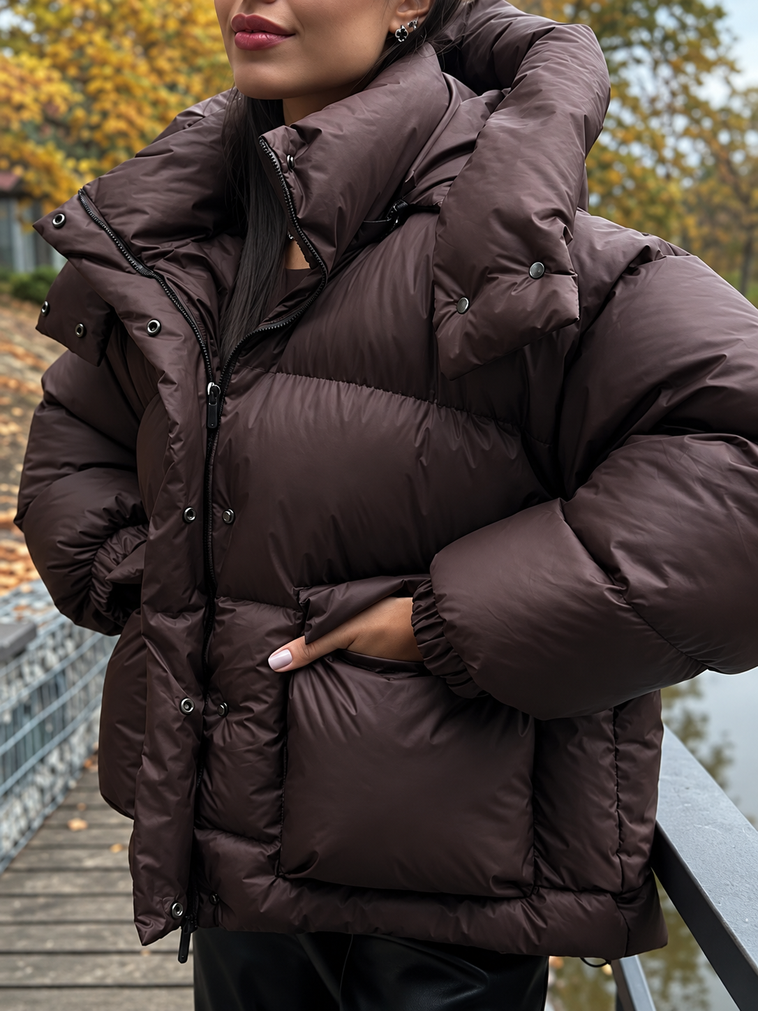 Women’s oversized quilted hooded puffer jacket, dark brown close-up of hood and zipper
