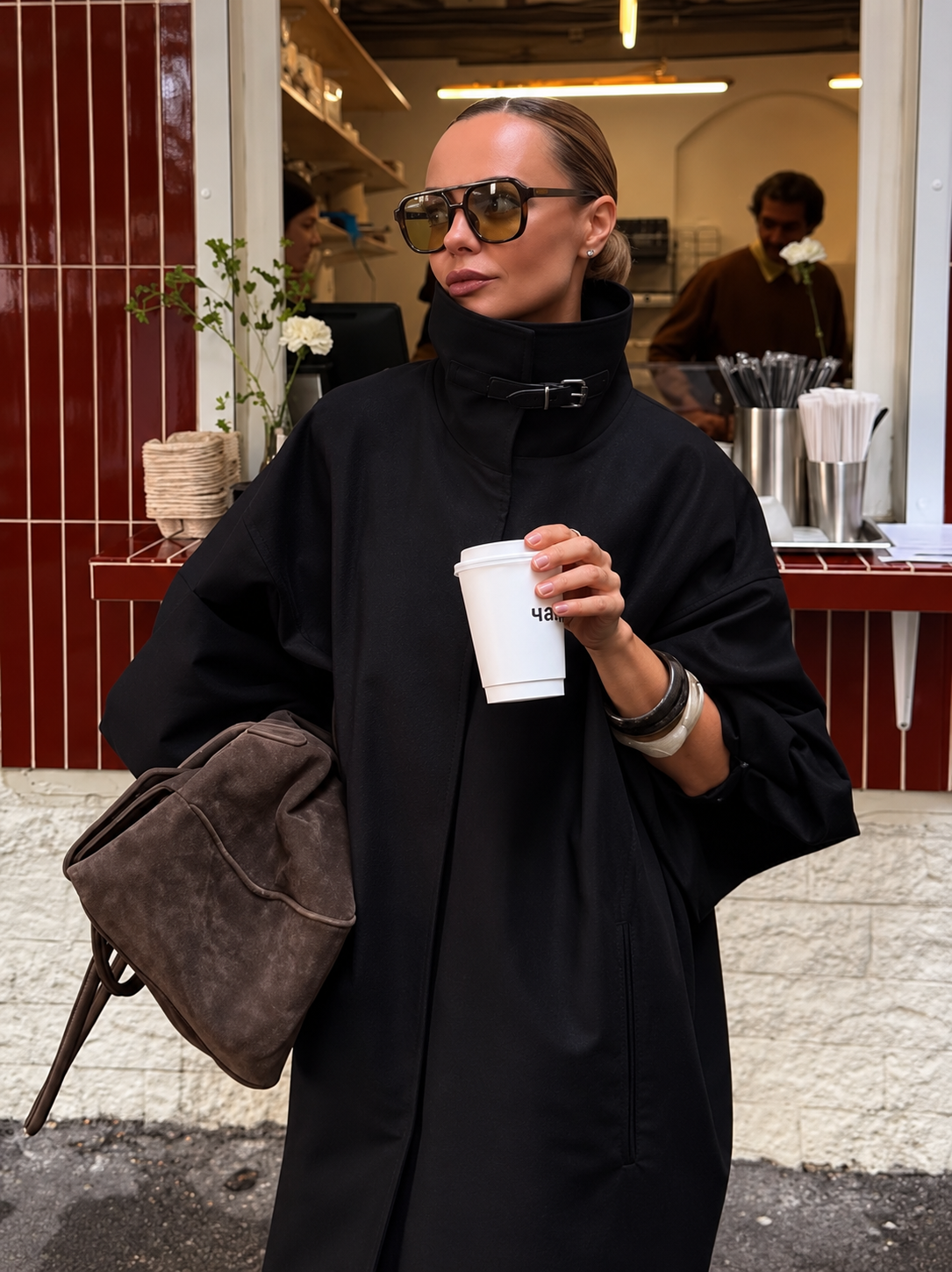 Black lace-up funnel neck trench coat with high collar and button front