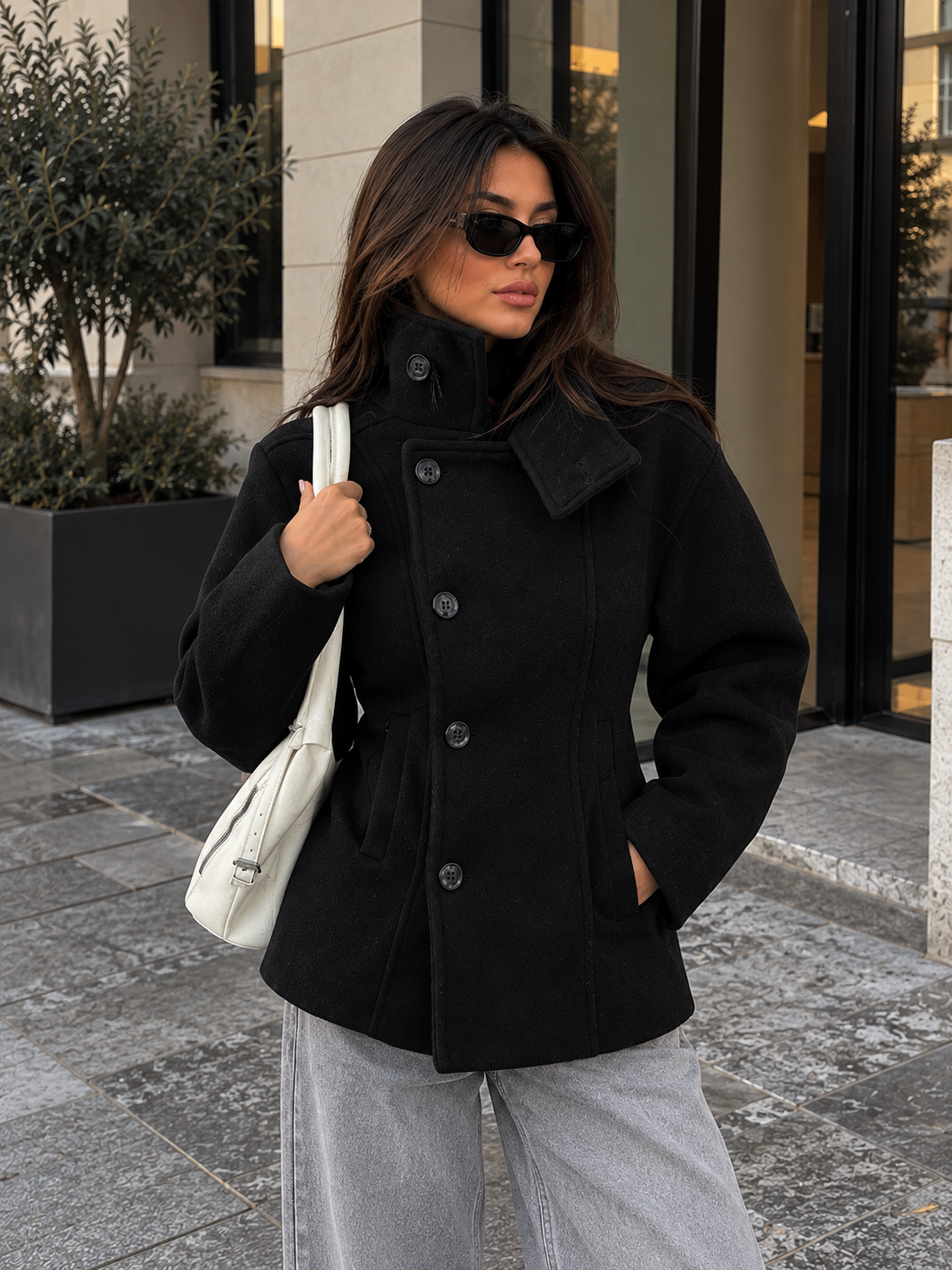 Black stand-collar wool pea coat with double-breasted buttons and shoulder seam