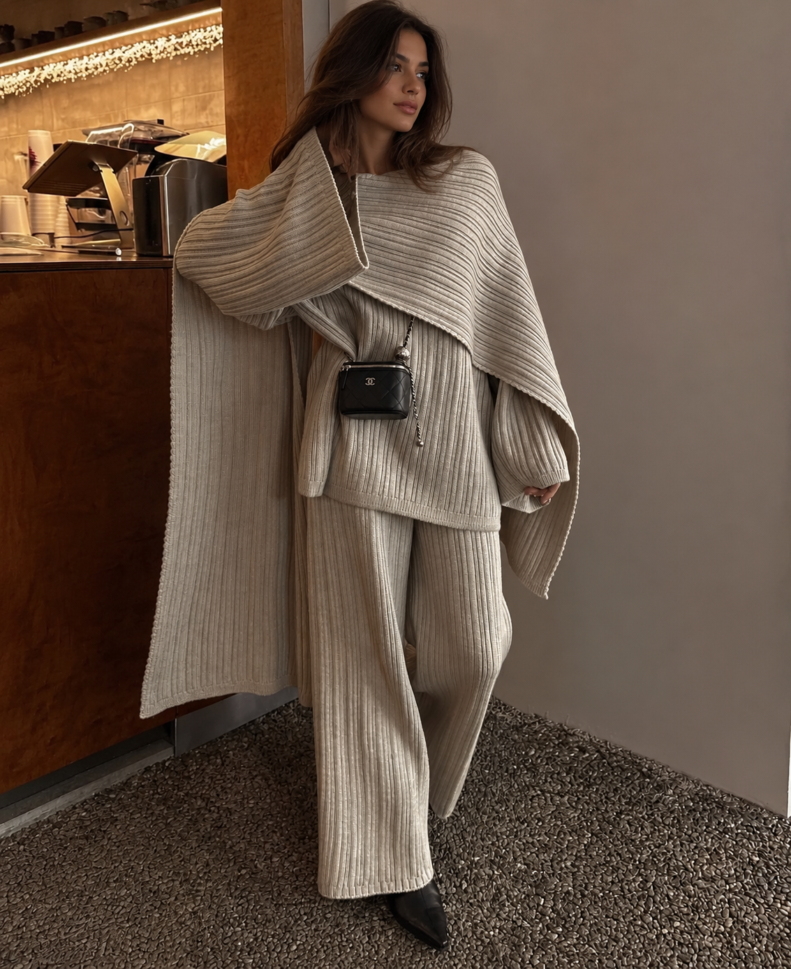 Light grey knitted three-piece sweater set with oversized wrap and matching ribbed pants