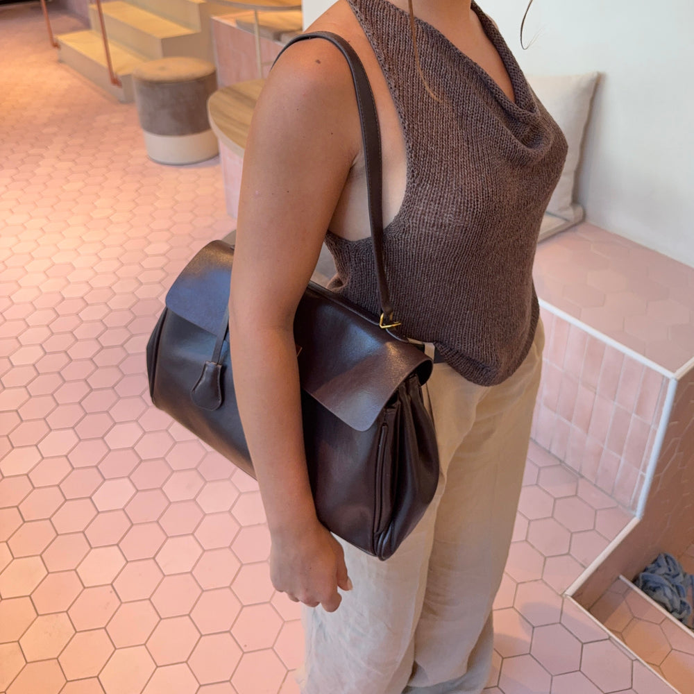 Ciara Vintage shoulder bag worn at the side, with a long strap and gathered side panels