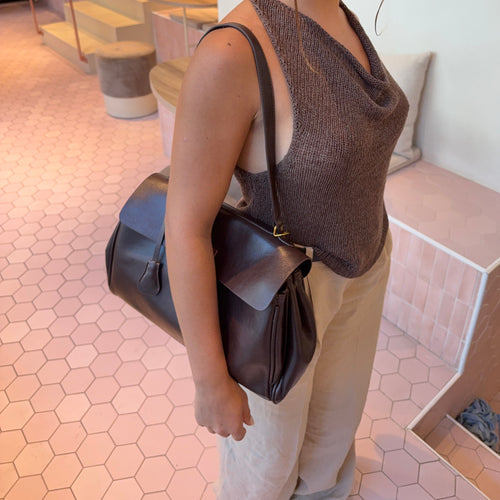Ciara Vintage shoulder bag worn at the side, with a long strap and gathered side panels