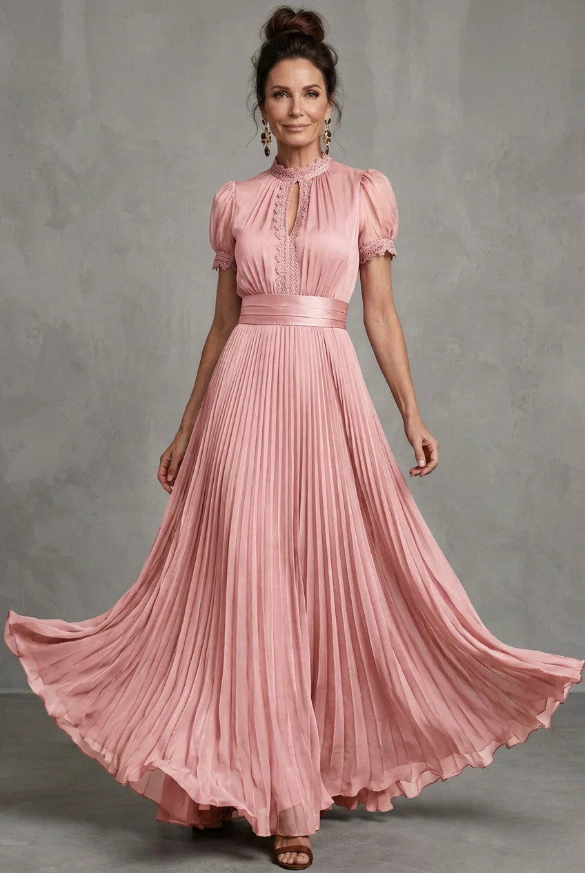 Pink pleated maxi dress with puff sleeves, high neck, and fitted waist