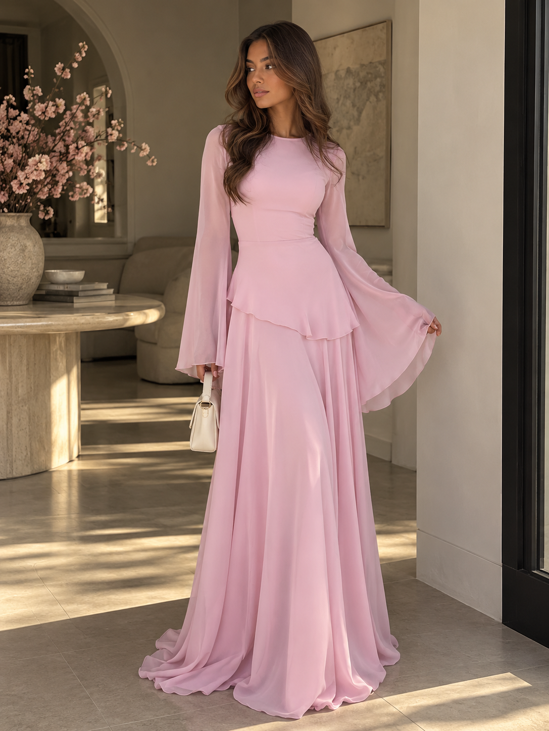 Light pink tiered maxi dress with long bell sleeves and tiered ruffle skirt