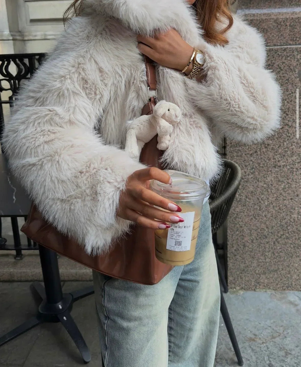 Light grey faux fur coat close-up with textured lapels and open front