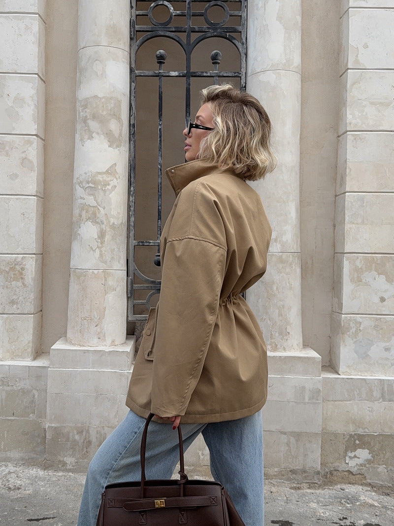 Khaki utility jacket for women with high neck, drawstring waist, snap front (back view)