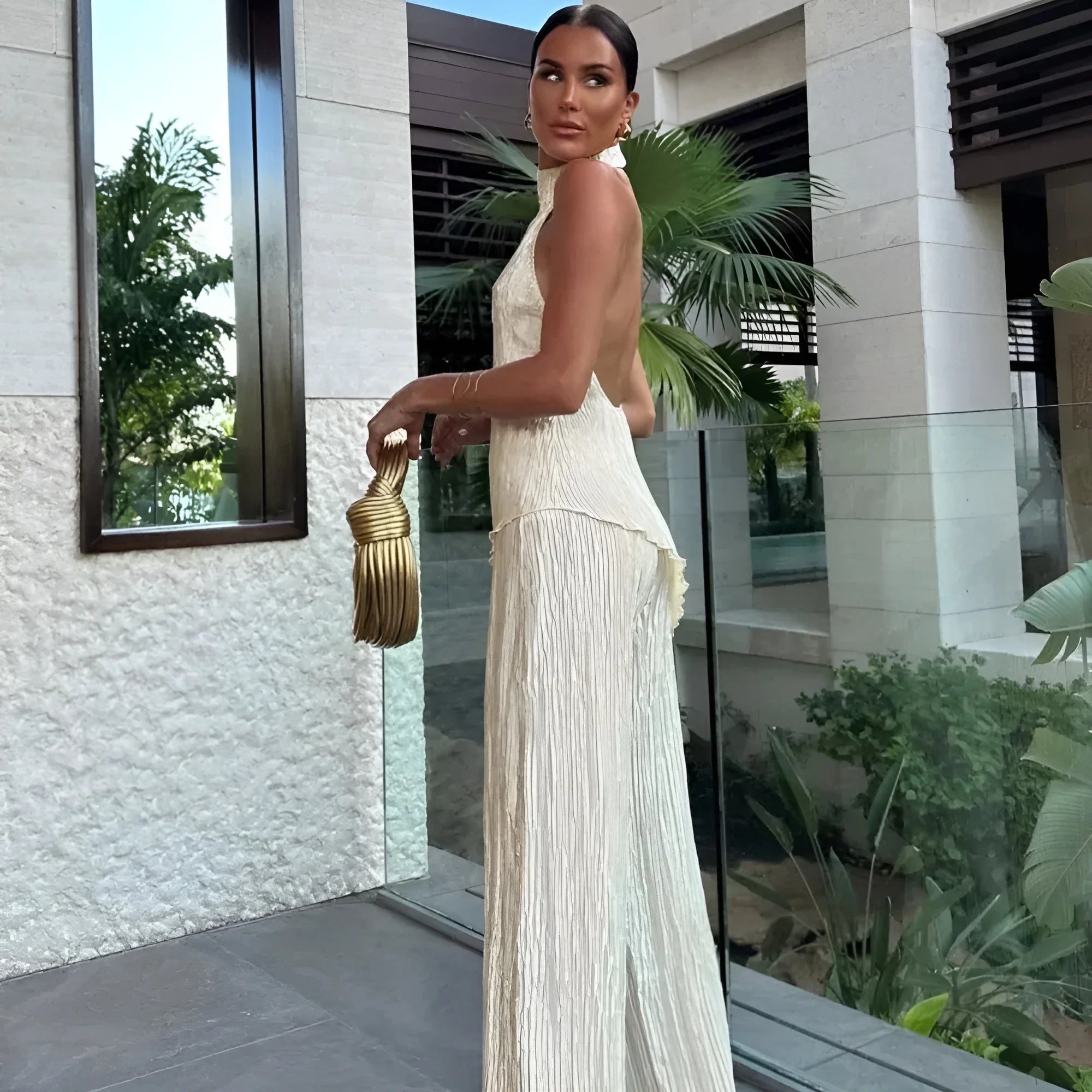 Cream asymmetric halter top with pleated wide-leg trousers co-ord set
