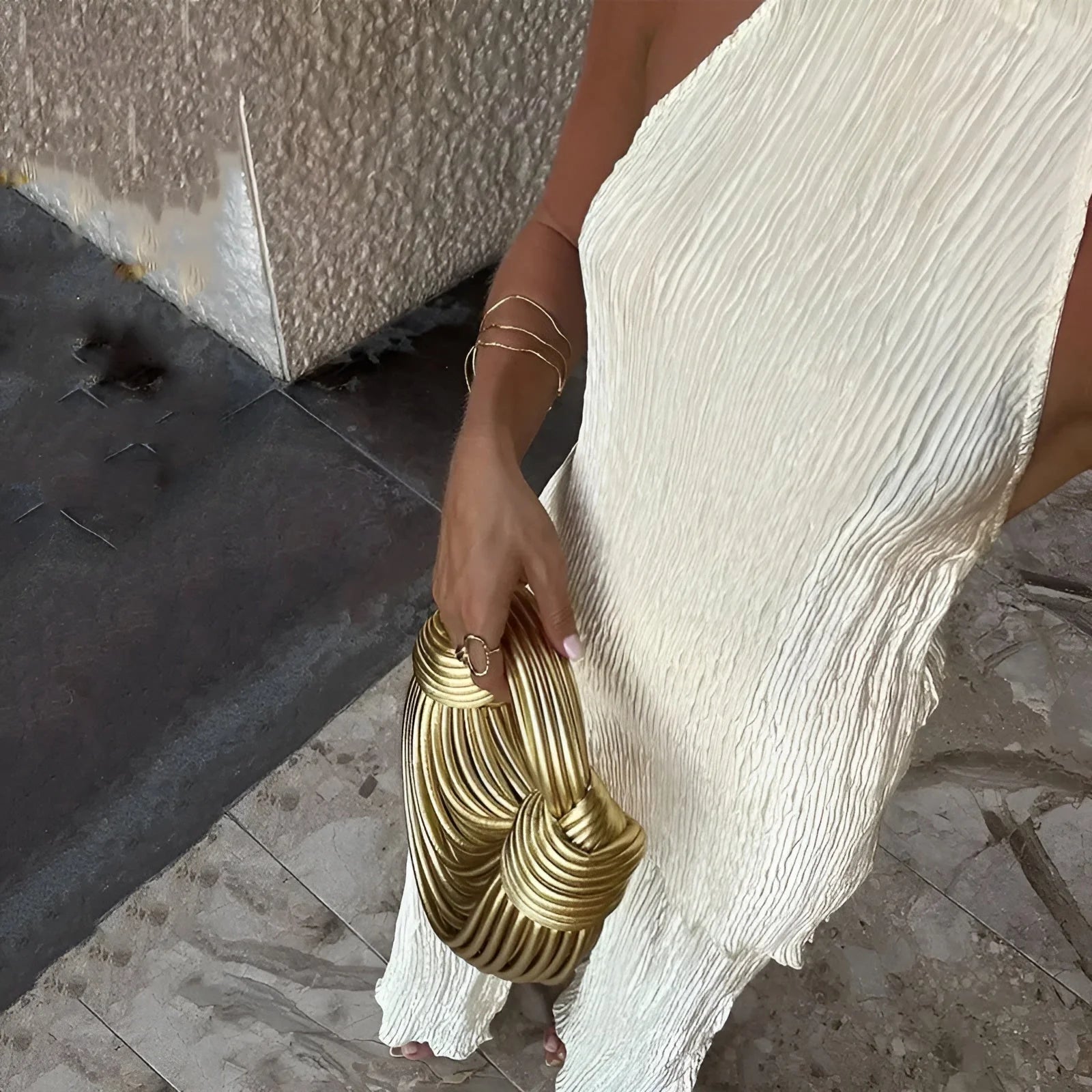 Ivory pleated wide-leg trousers with halter top detail and draped asymmetric hem