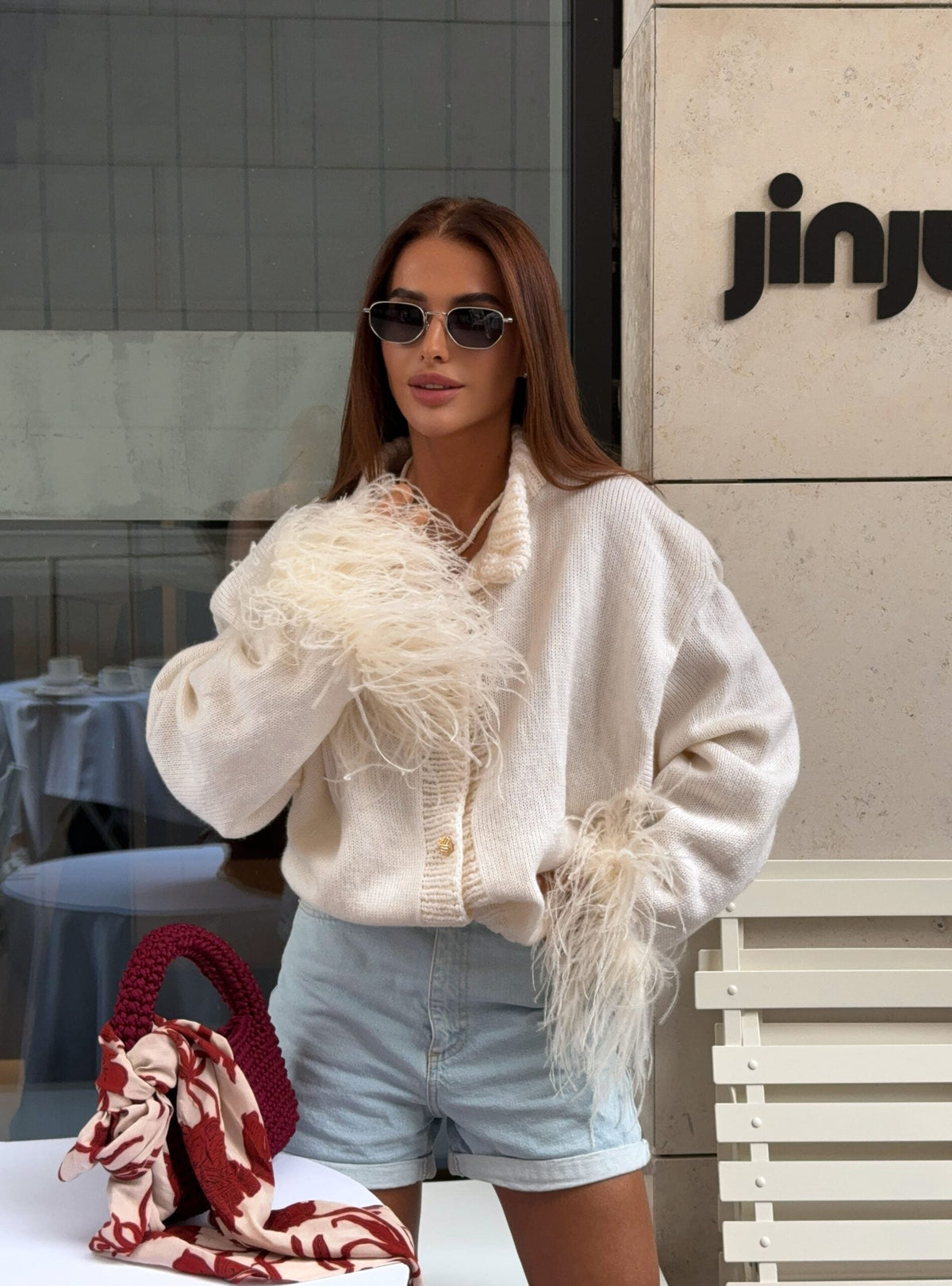 White knit V-neck cardigan with button front and fluffy feather-trim sleeves