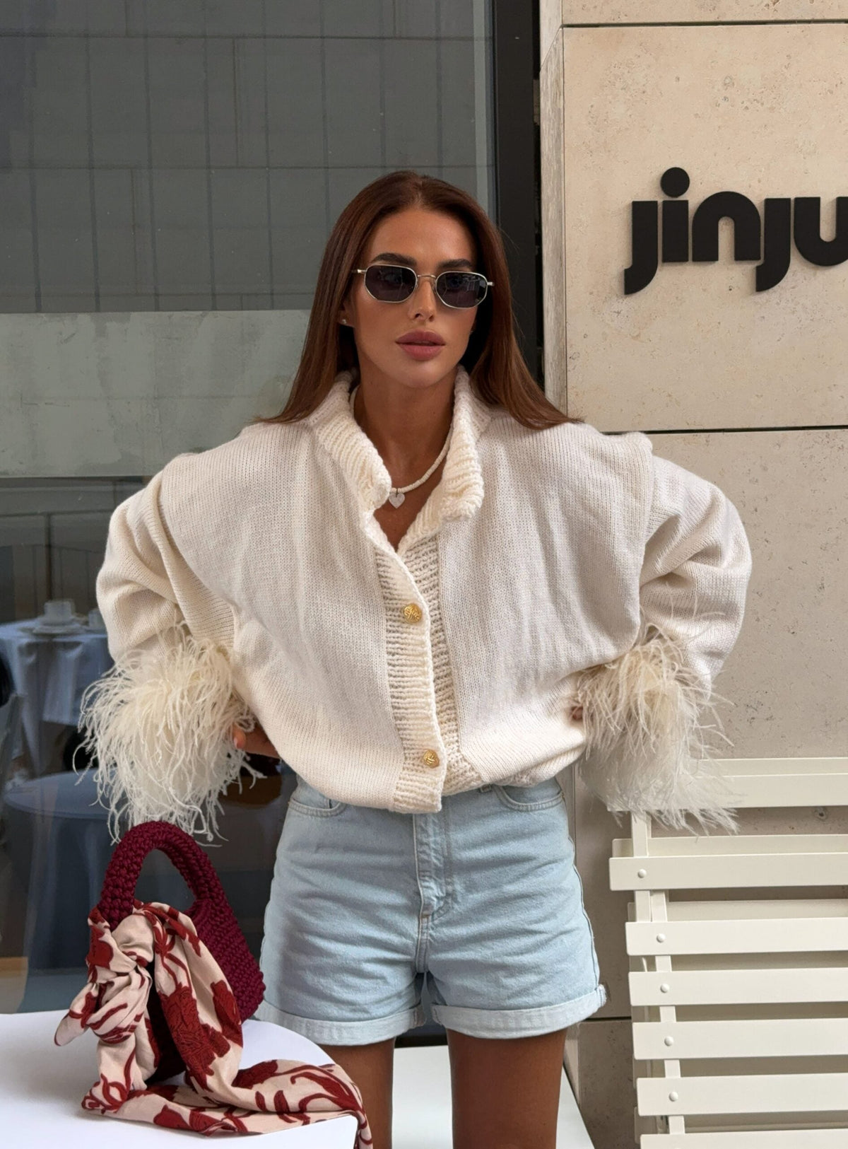 White button-front V-neck knit cardigan with feather-trim cuffs and airy texture