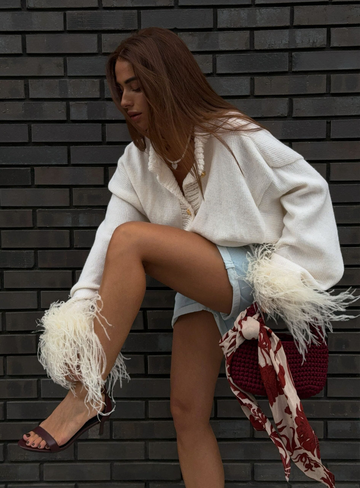 White knit V-neck cardigan with button front and feather-trim sleeve cuffs