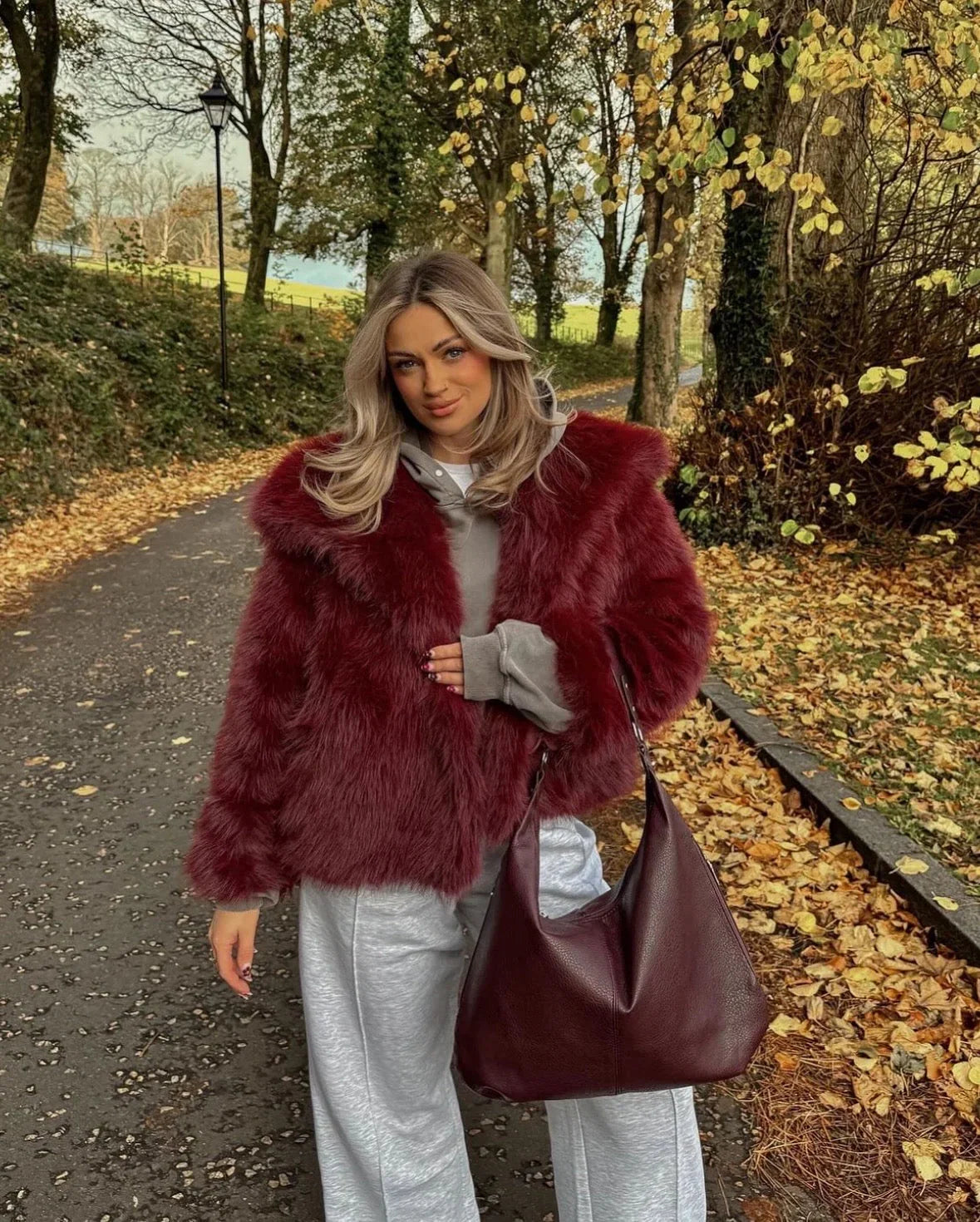 Burgundy oversized faux fur coat for women with front button closure and long sleeves
