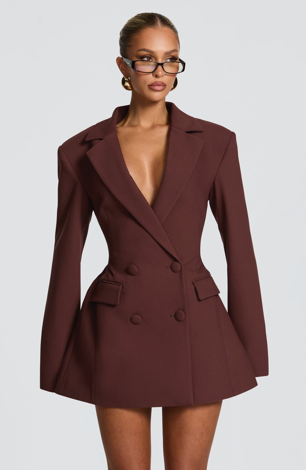 Wine double-breasted blazer mini dress with long sleeves, peak lapels, and flap pockets.