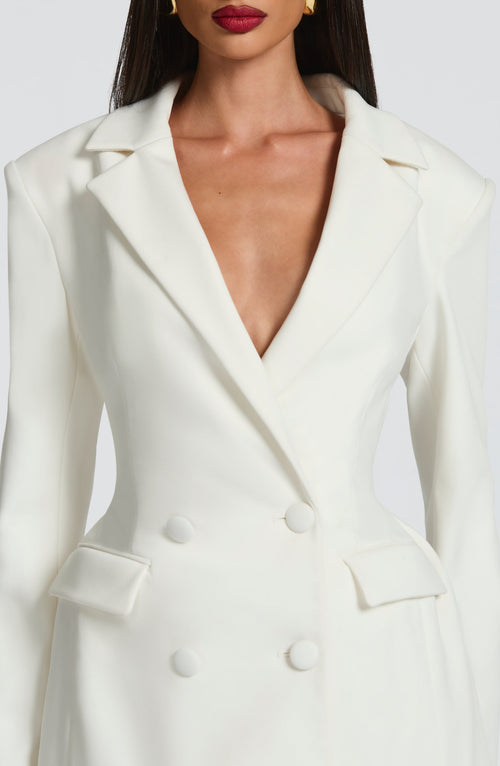 White mini blazer dress close-up of V-neck, button front, and shoulder tabs