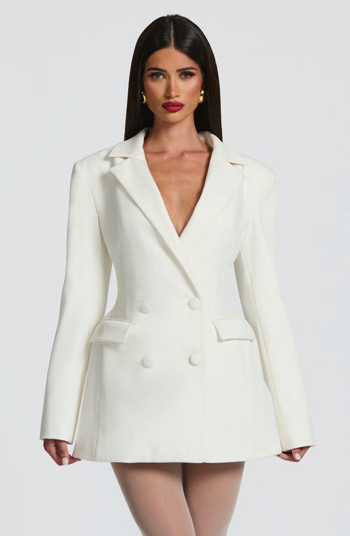 Ivory double-breasted blazer mini dress with long sleeves, peak lapels, and flap pockets.