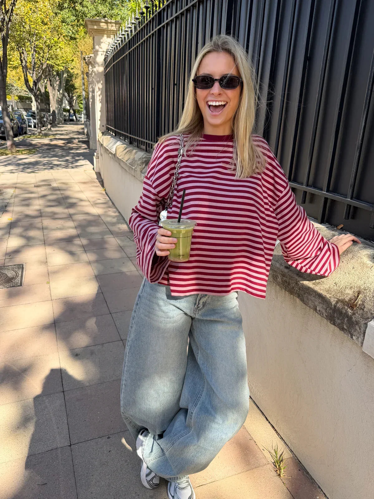 Women’s oversized striped knit sweater with long sleeves and red-and-white stripes