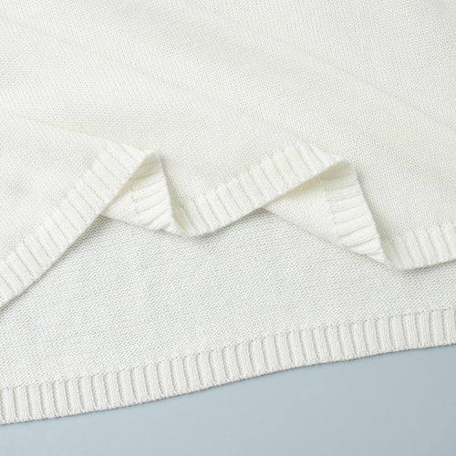 Off-white knit sweater hem detail, ribbed trim and textured knit