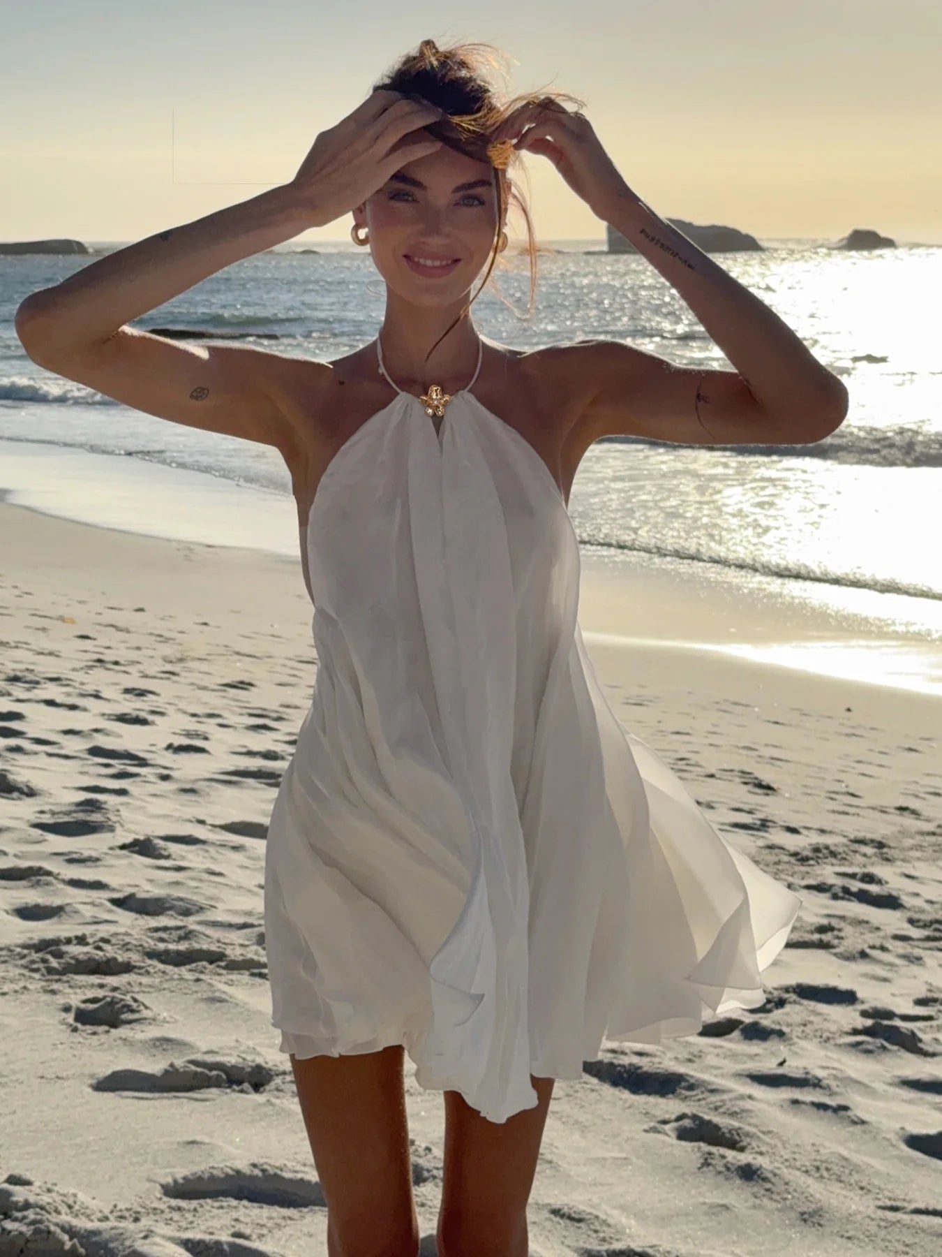 White halter ruffle mini dress with flowy tiered skirt and open halter neckline