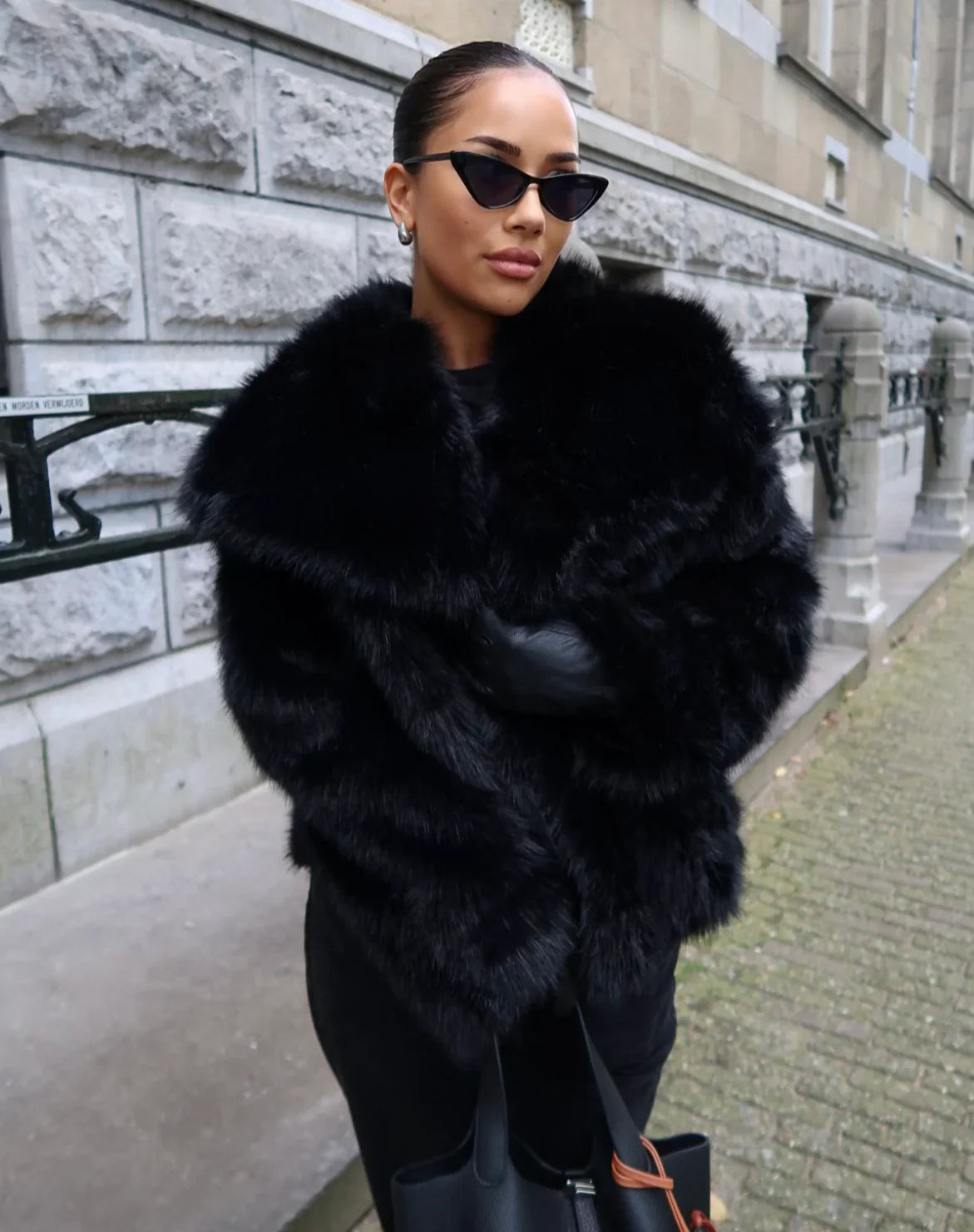 Black faux fur oversized jacket with plush texture and wide collar