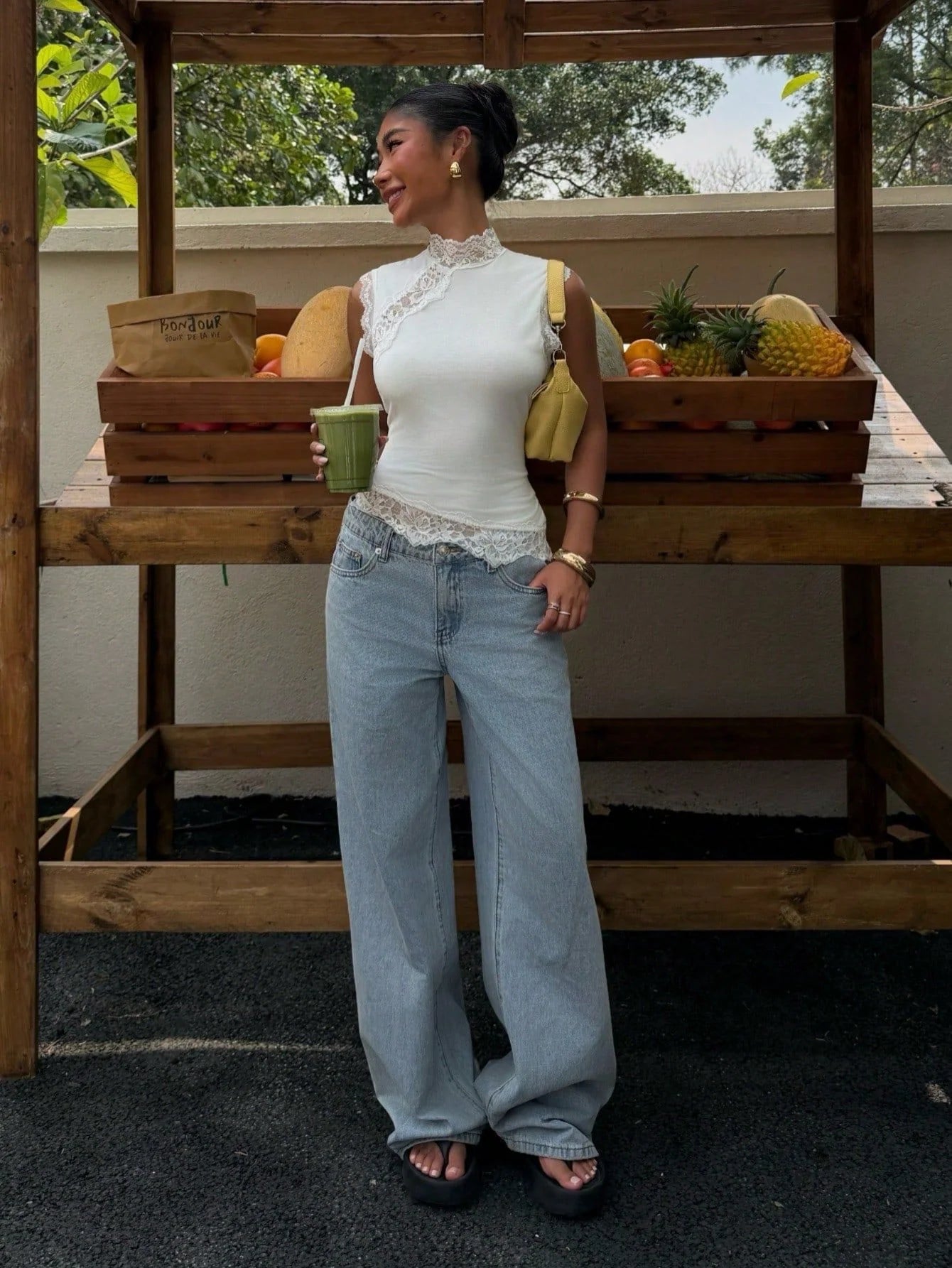 White lace-trim mock neck sleeveless top worn with light blue jeans