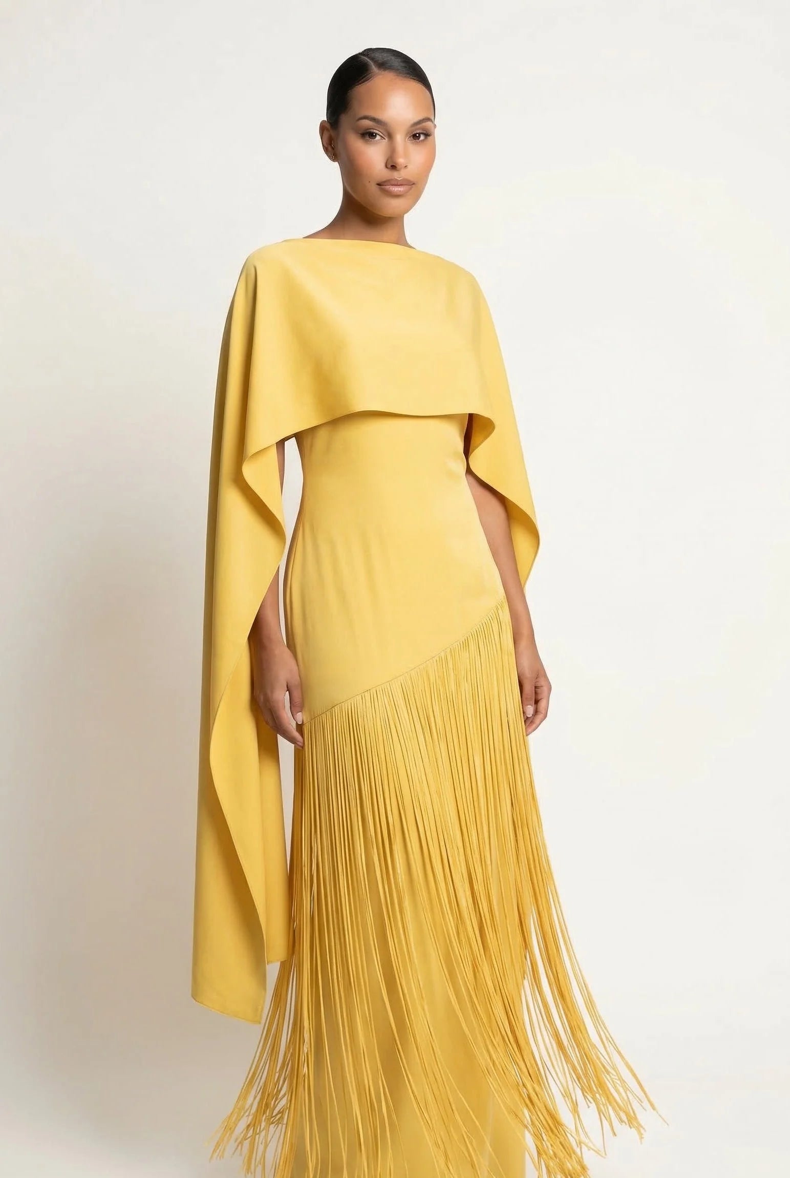 Yellow maxi gown with draped cape sleeves and long fringe hem detail