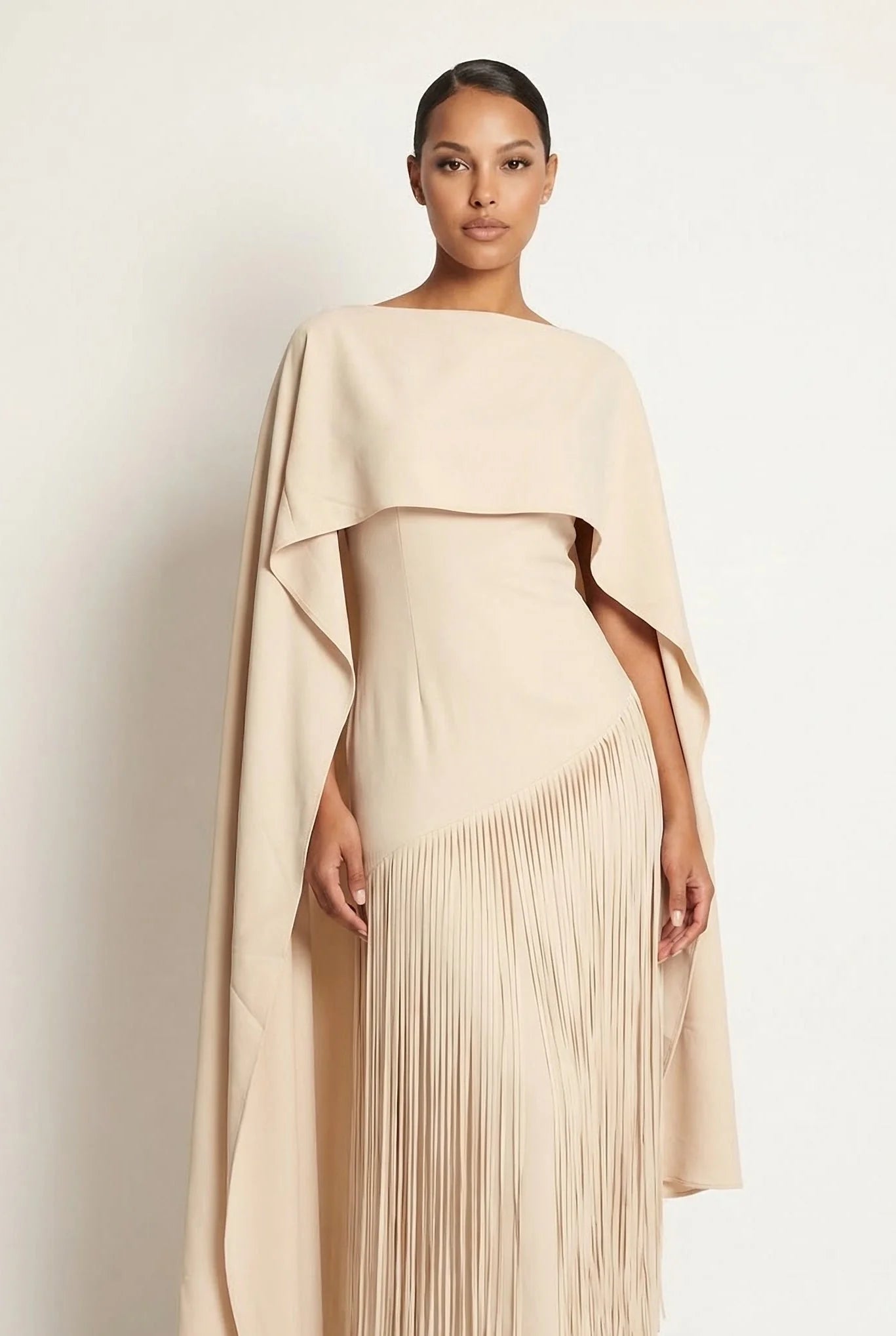 Champagne maxi gown with draped cape sleeves and fine fringe at the hem