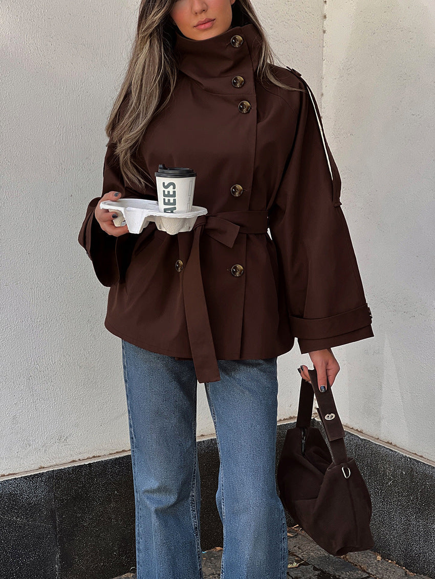 Women's brown belted trench jacket with high neck, double buttons, flap pockets and tabs