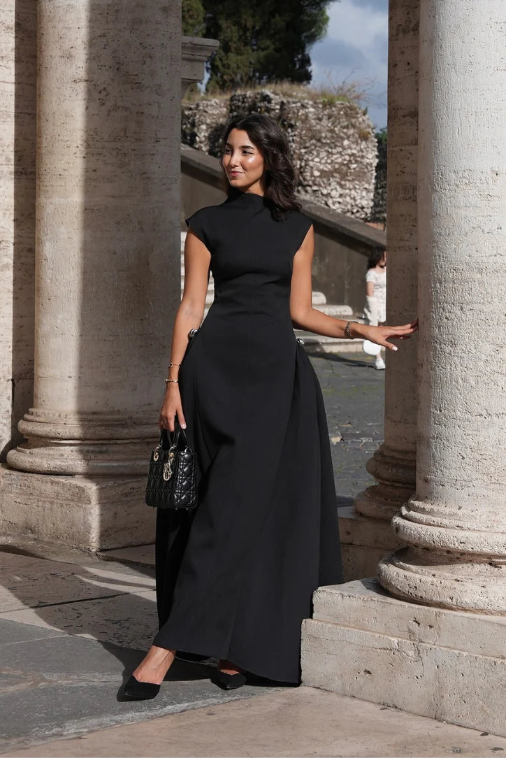 Black sleeveless mock-neck maxi gown with fitted waist and slightly flared hem
