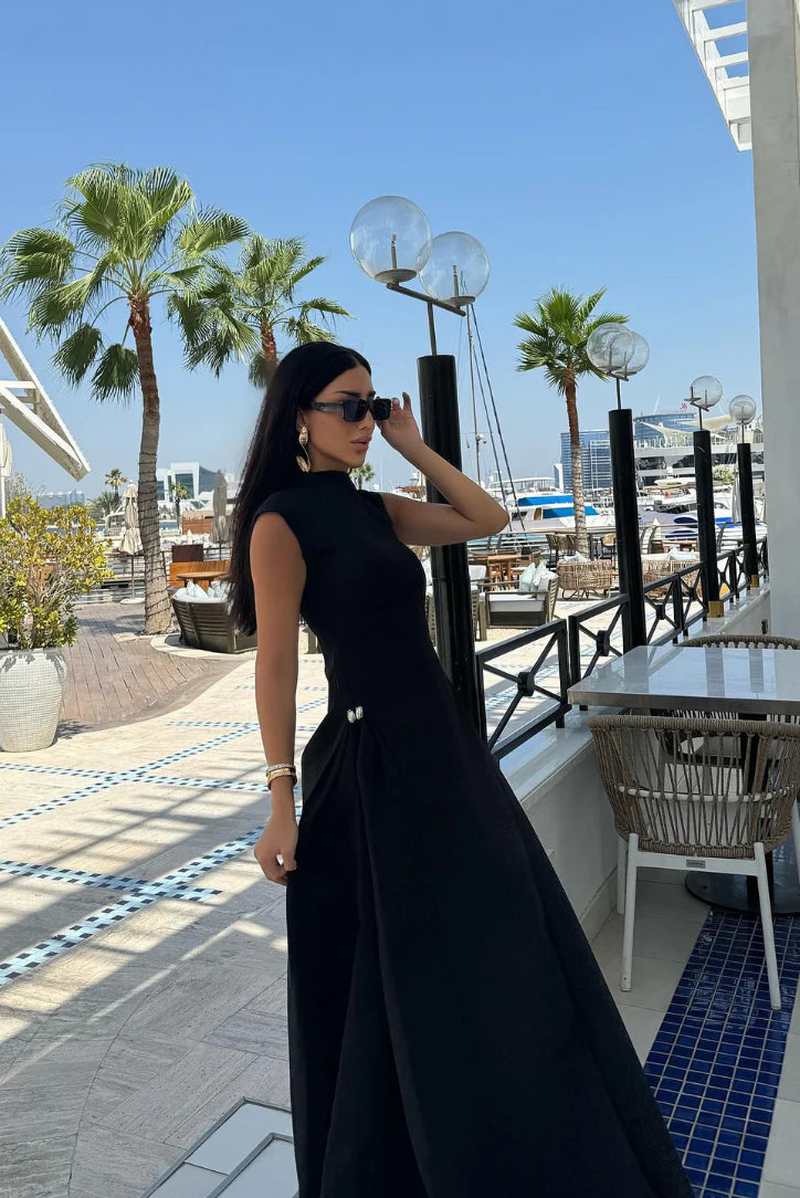 Black mock-neck sleeveless maxi gown with short sleeve shoulders and full length skirt