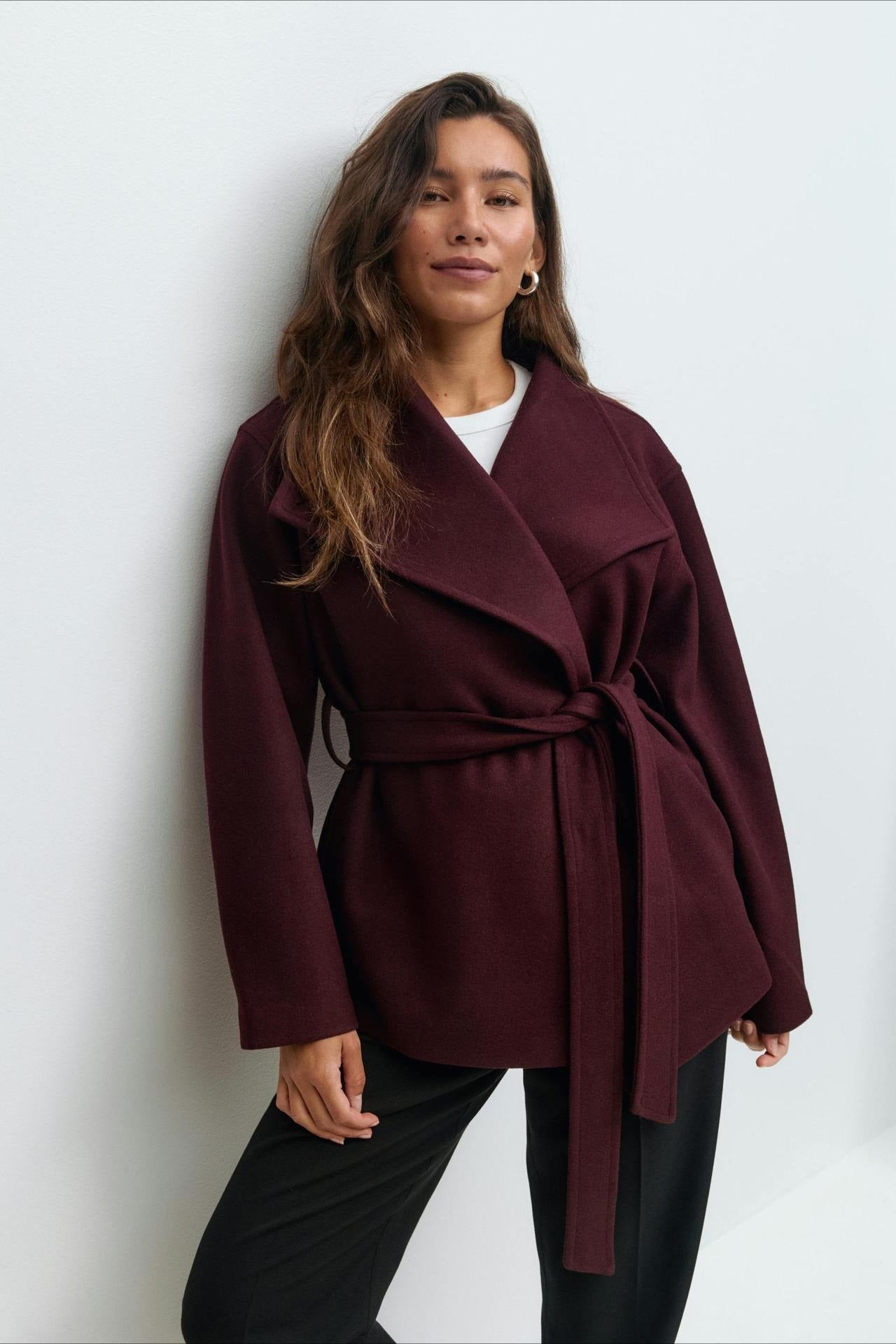Dark red belted wrap jacket coat with high neck and long sleeves