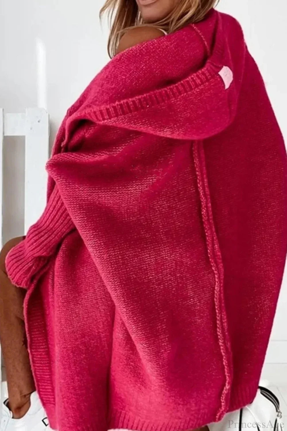 Women’s hooded open-front long knit cardigan in deep pink, side view with hood up