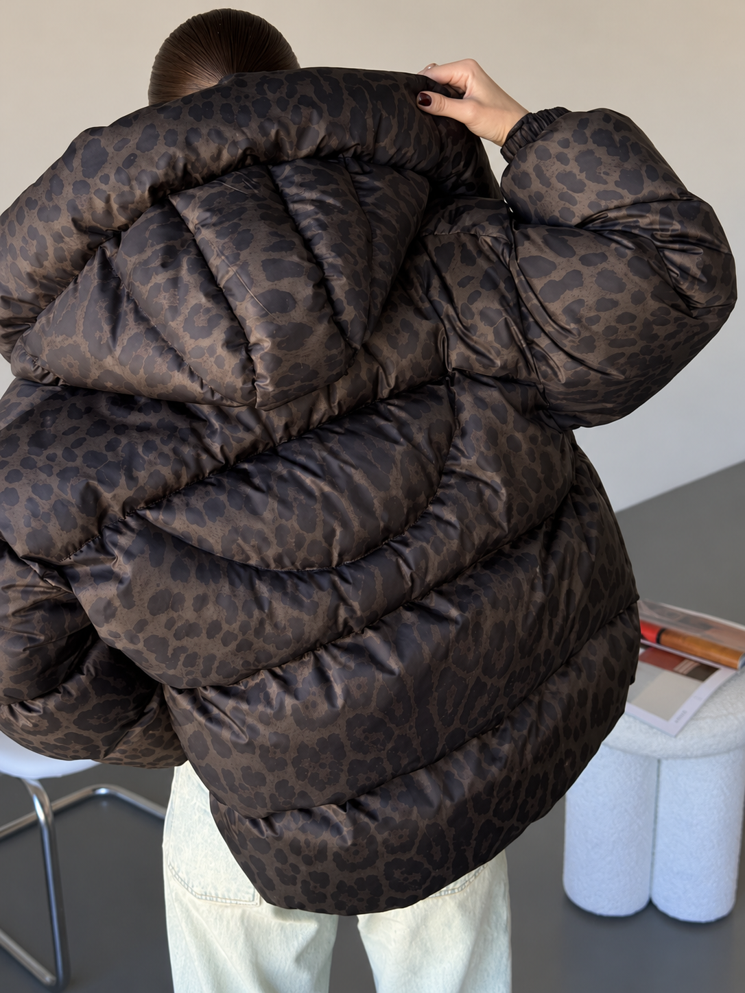 Leopard print puffer jacket showing quilted baffles and voluminous sleeves