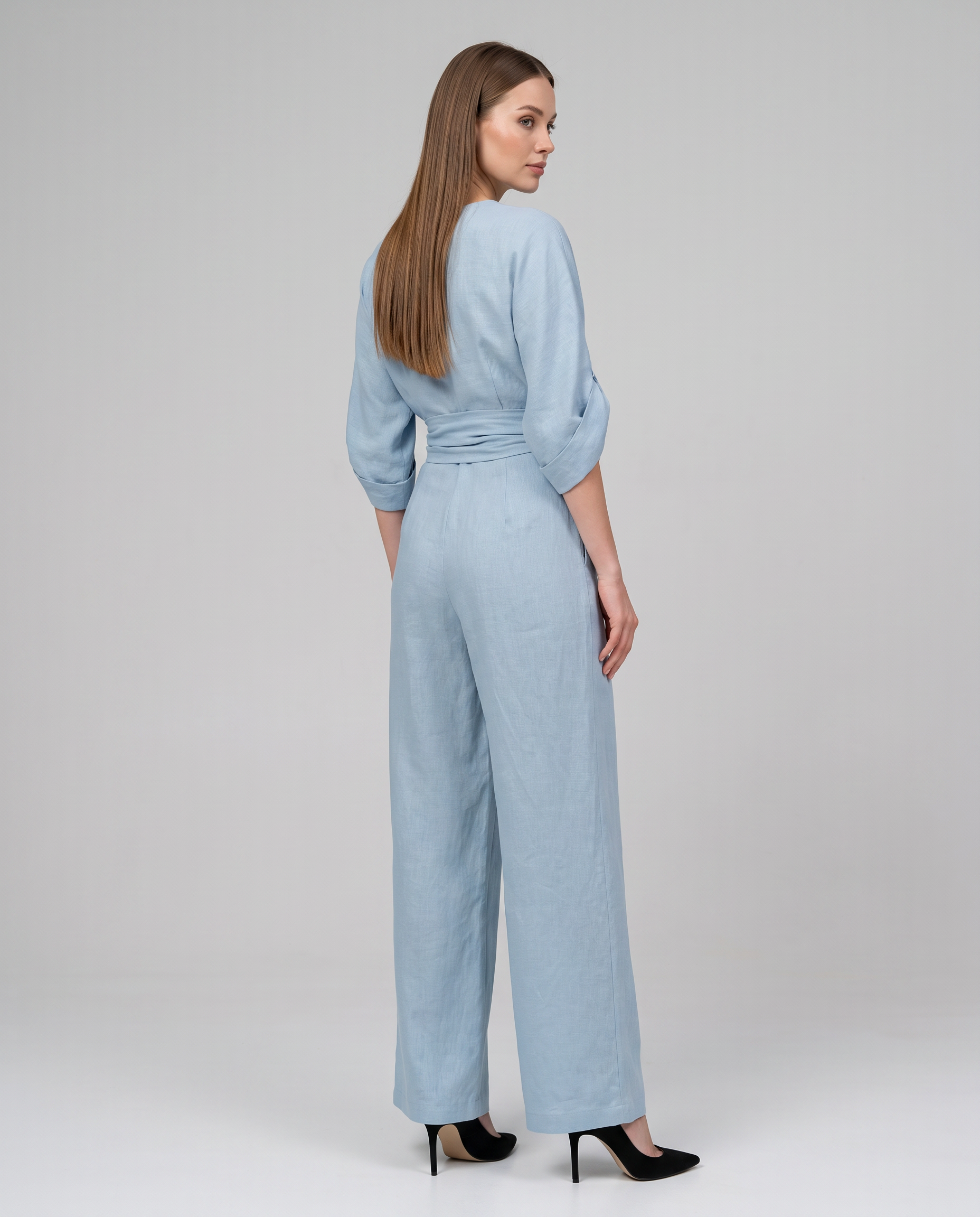 Light blue wrap waist V-neck wide-leg jumpsuit, back view with tie at waist