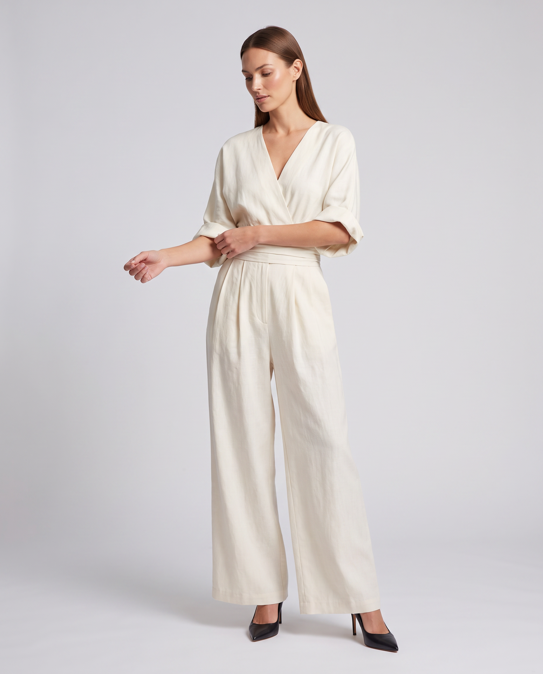 White V-neck wrap waist wide-leg jumpsuit with belted tie and elbow-length sleeves