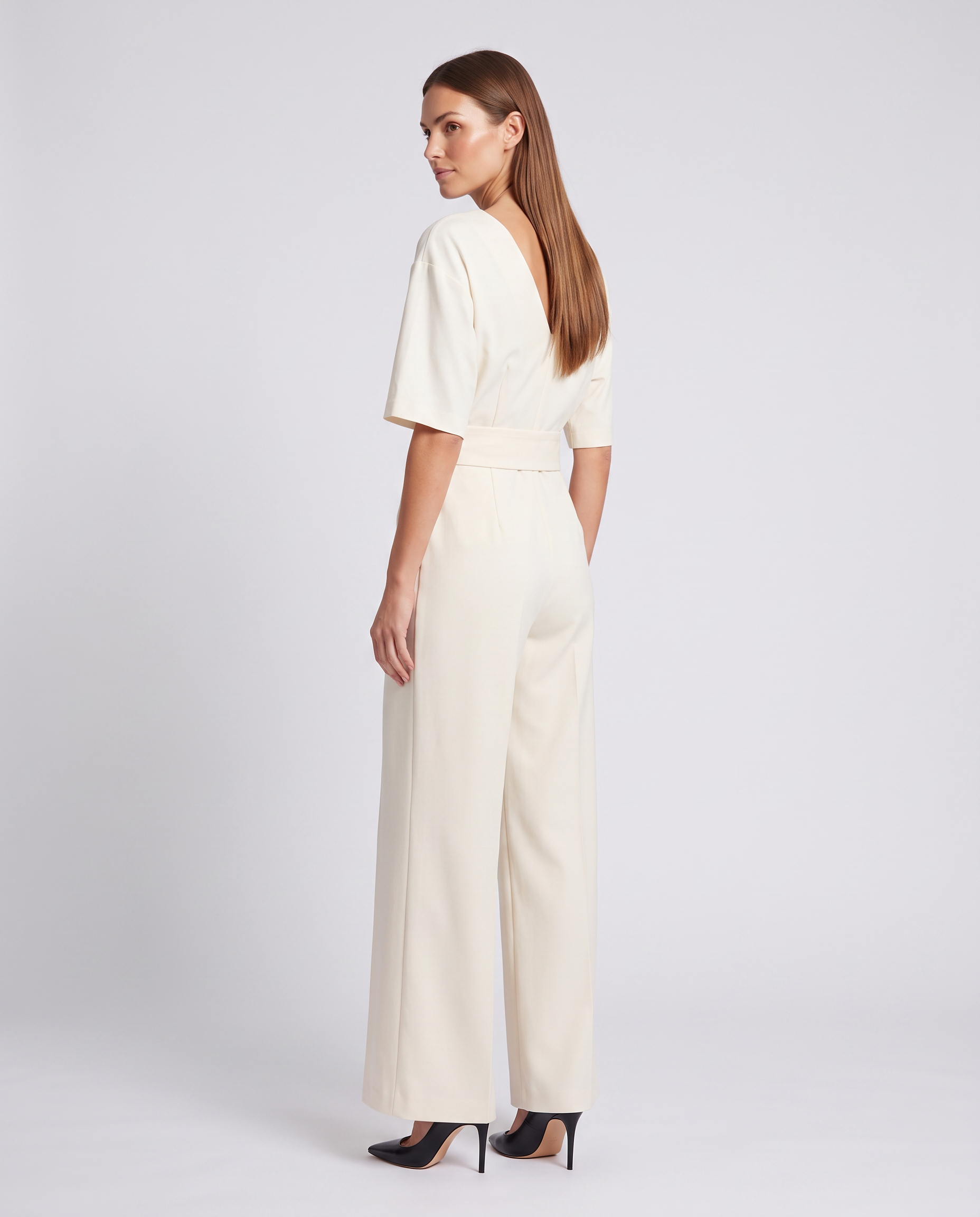 White wrap waist V-neck wide-leg jumpsuit, back view with tie at waist and wide legs
