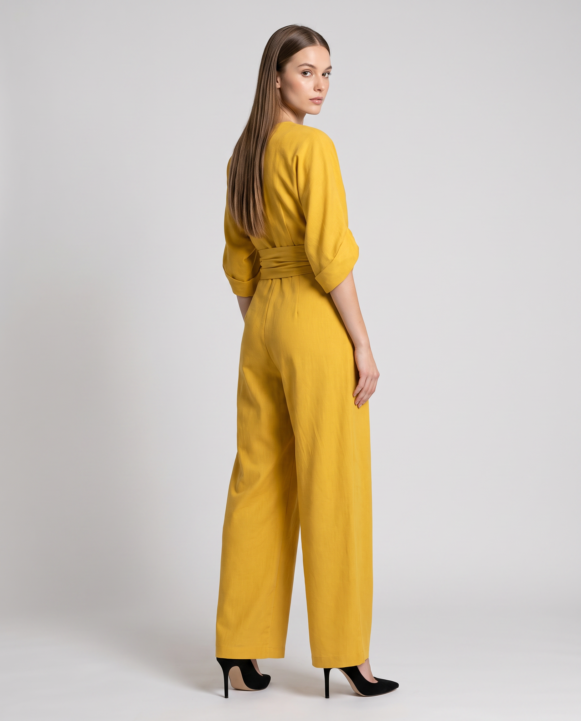 Yellow wrap waist V-neck wide-leg jumpsuit, back view with belted tie and wide legs