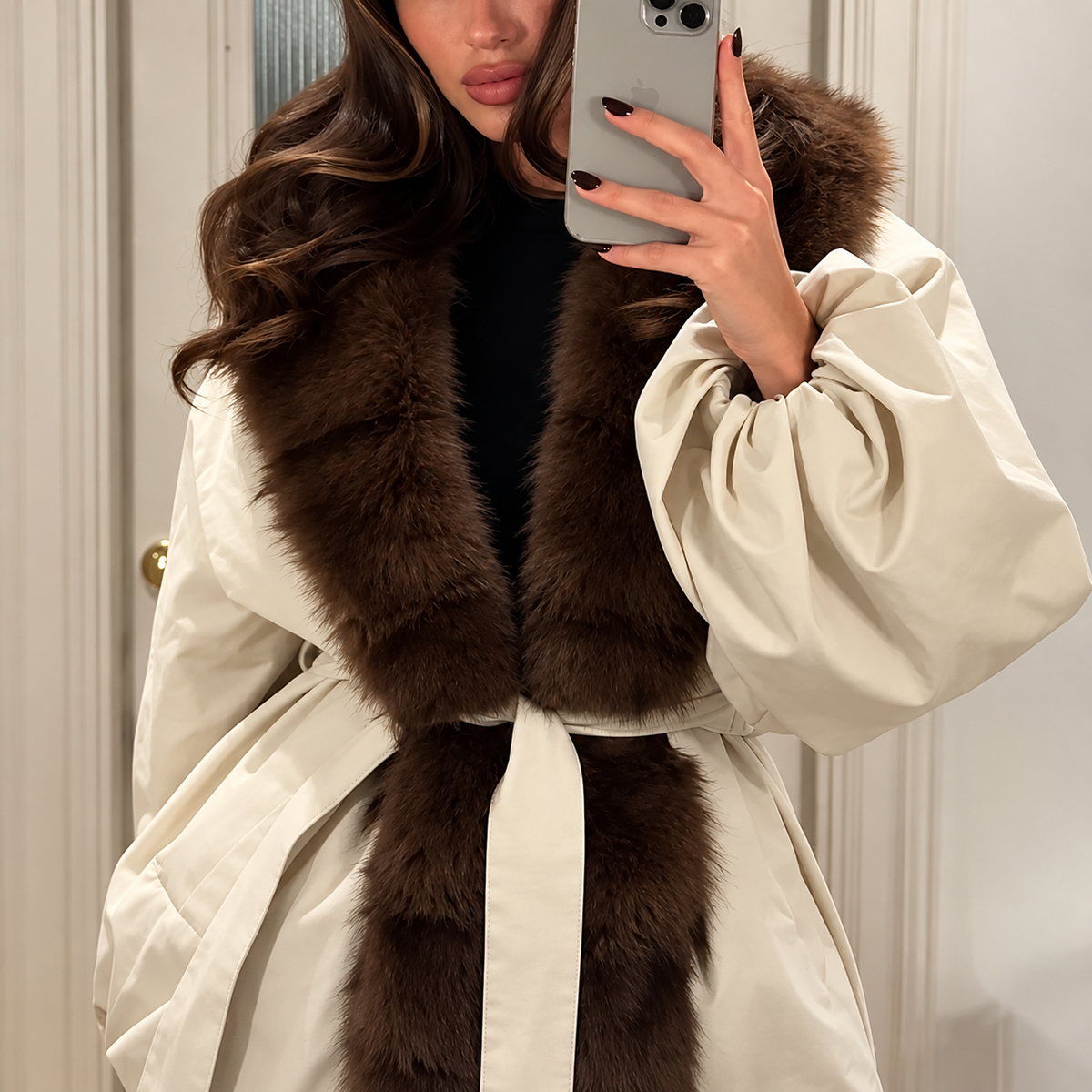 White quilted puffer bomber close-up with brown fur collar and belted waist