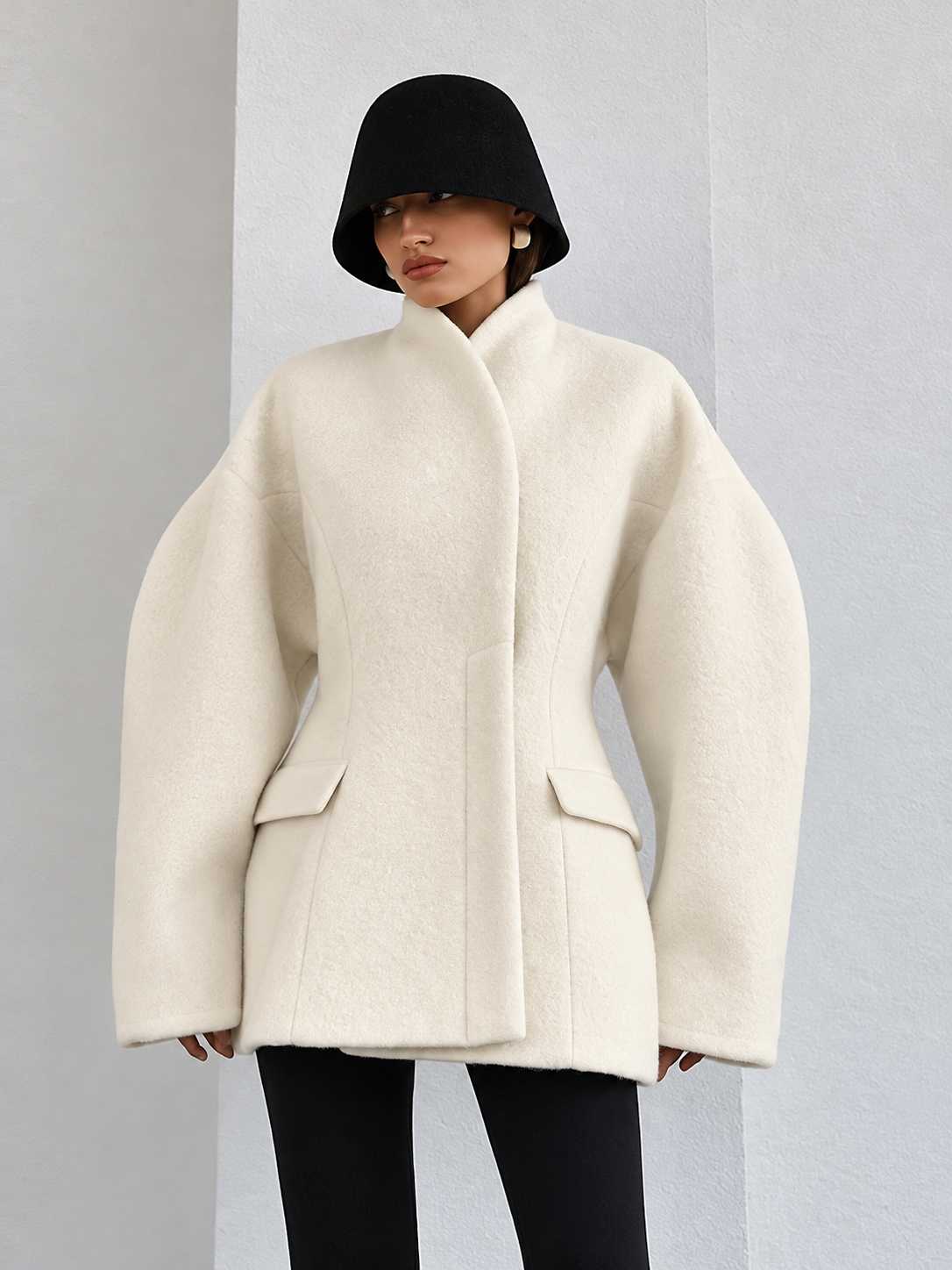 White wool coat with button front, raised collar, and flap pockets