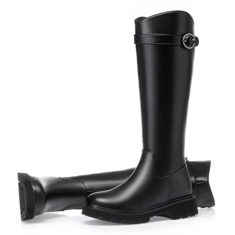 Black tall riding boots, side view with buckle strap and thick tread sole