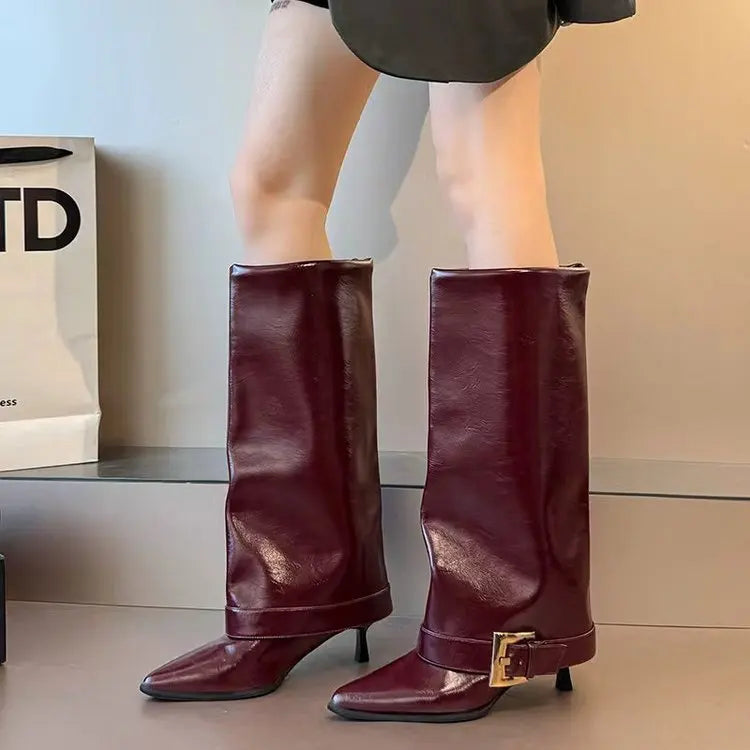 Burgundy knee-high stiletto boots with pointed toe, front buckle, and low platform heel