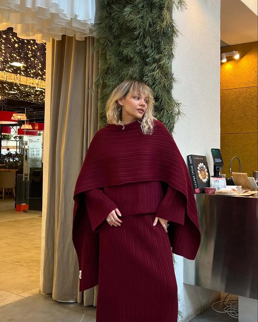 Burgundy knitted three-piece sweater set with draped poncho top and wide-leg pants