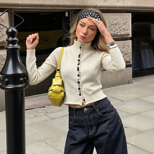 Cream knit turtleneck cardigan with button-front placket and long sleeves