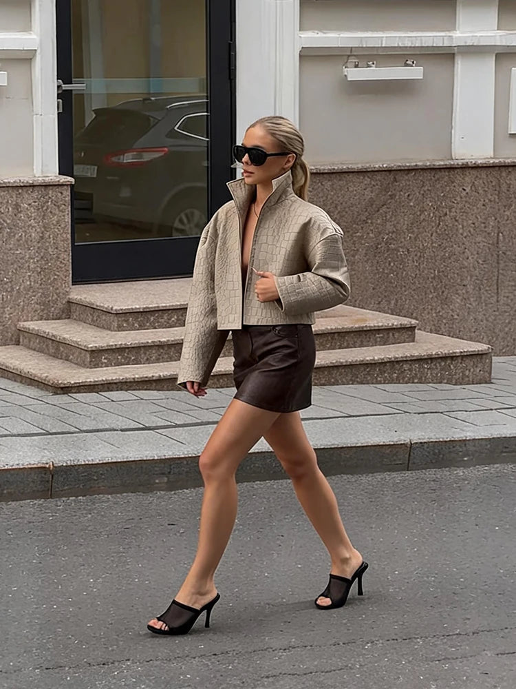 Light khaki leather-grain loose jacket with stand collar and zipped front.