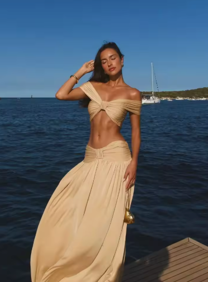 Sand off-shoulder knotted crop top and pleated gathered maxi skirt