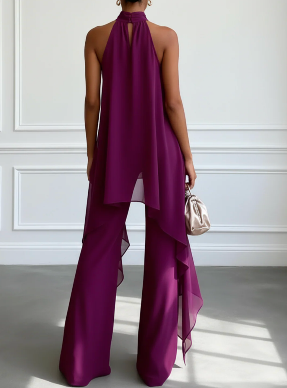 Back view of purple halter draped top with asymmetrical overlay and wide-leg trousers